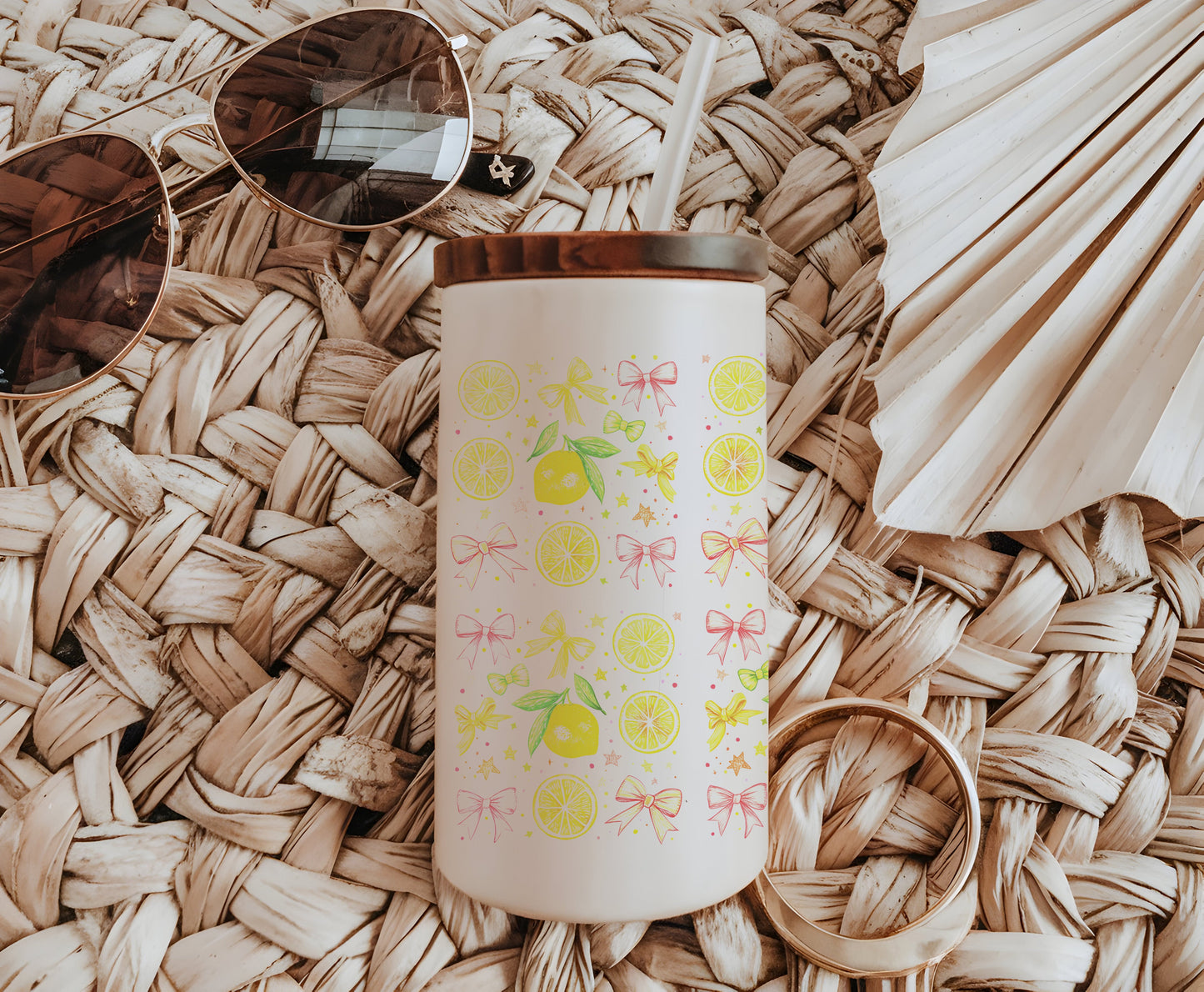 a cup with a straw lid sitting on top of a woven mat