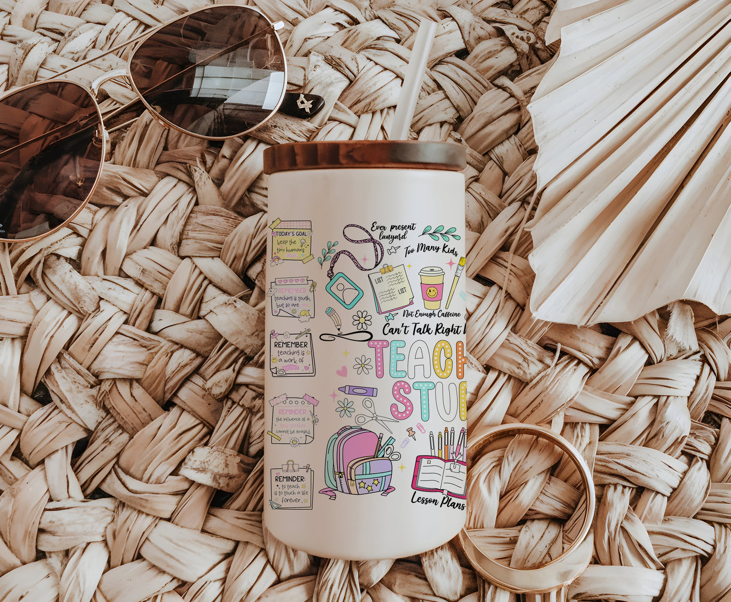 a coffee cup with a straw hat and sunglasses on top of it