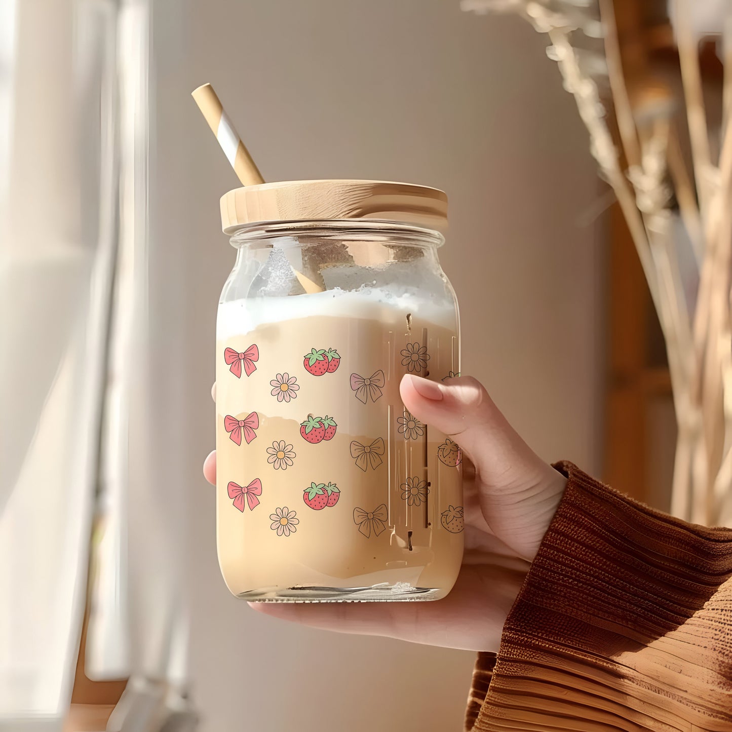 a person holding a jar with a straw in it