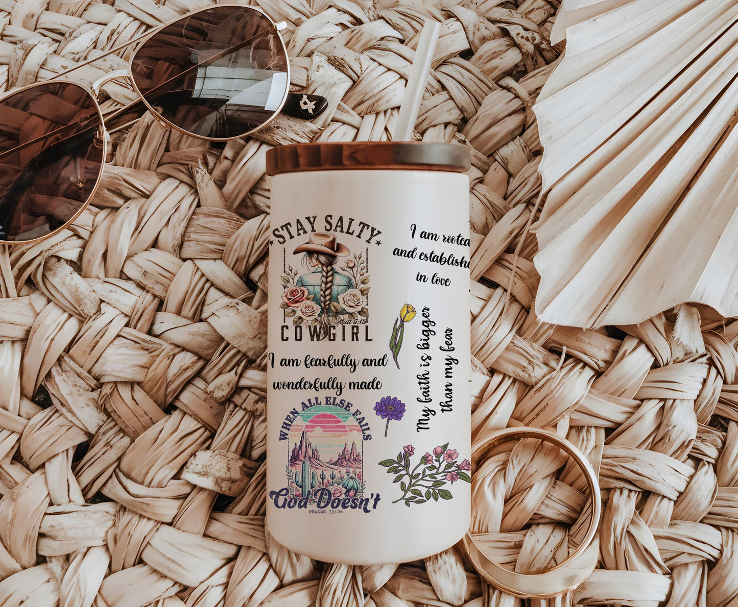 a coffee cup with a straw hat and sunglasses on top of it