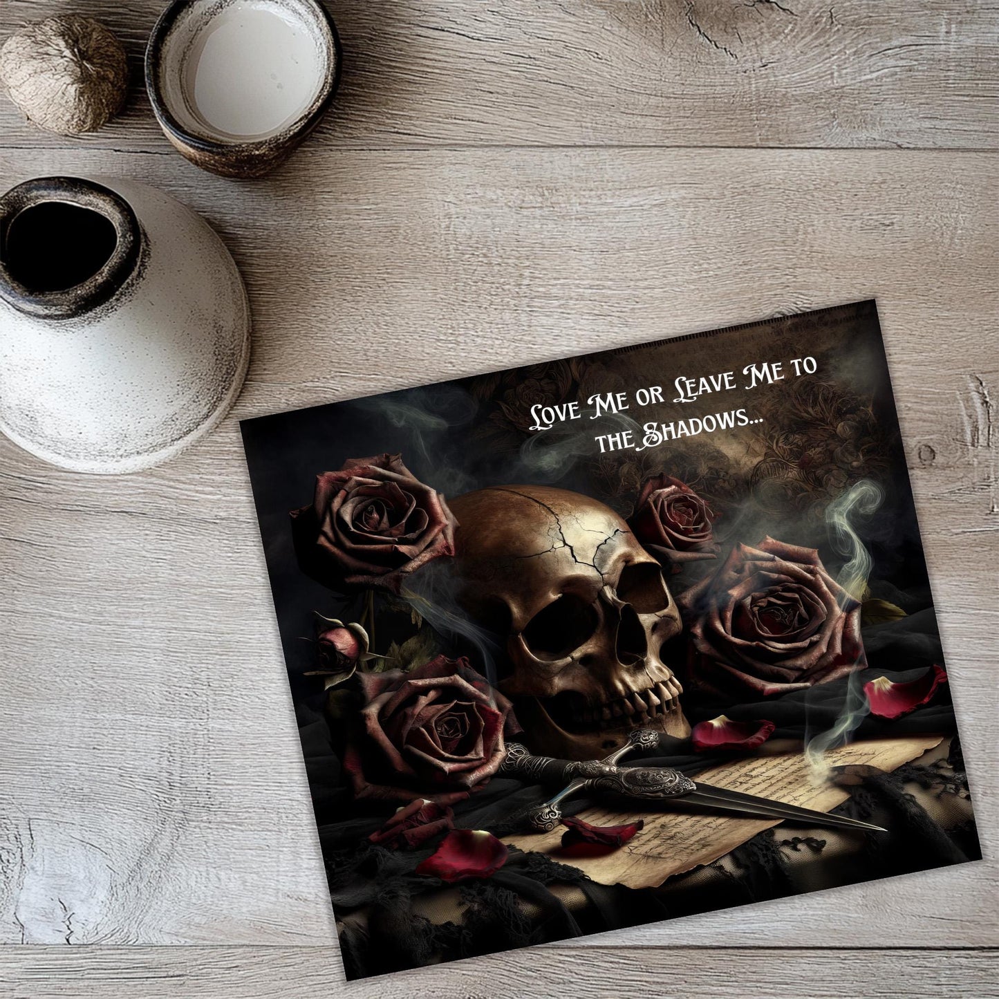 a picture of a skull and roses on a table