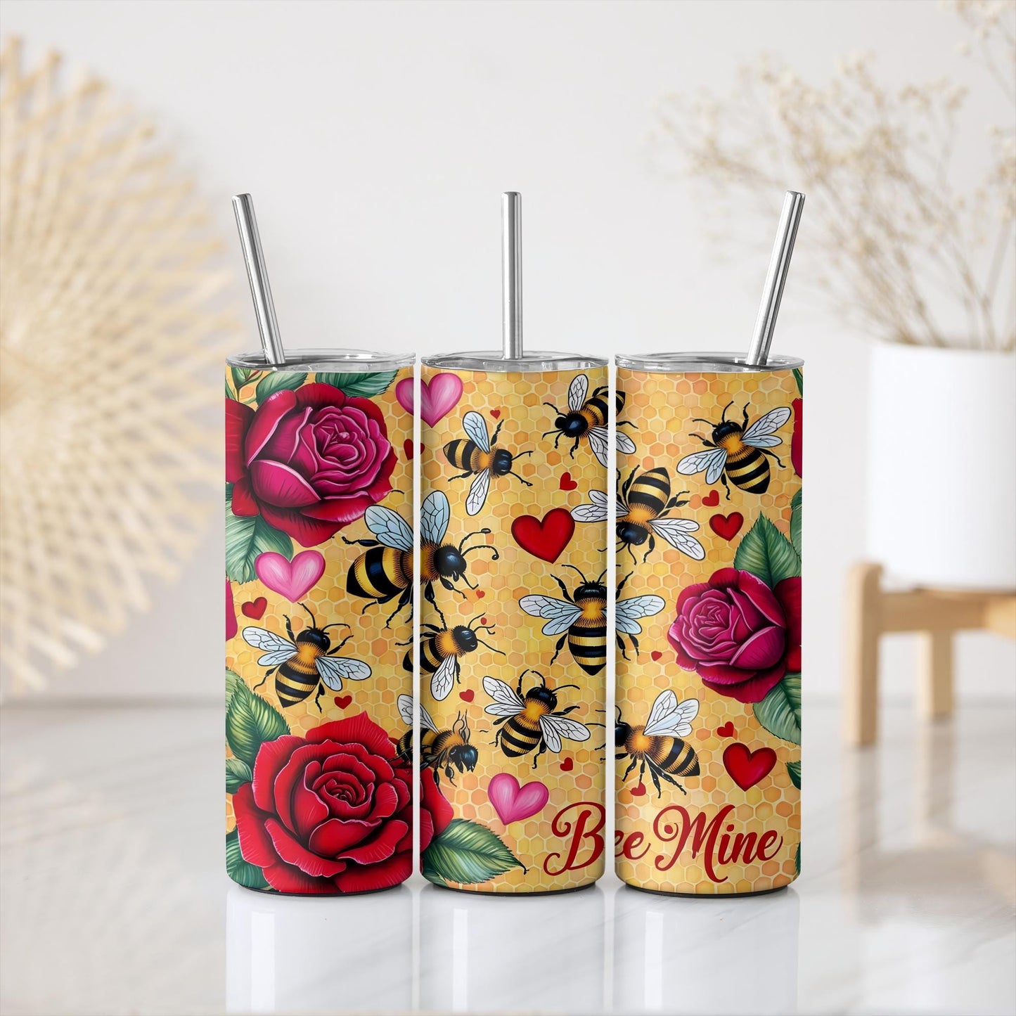 a set of three tumbles with bees and roses on them