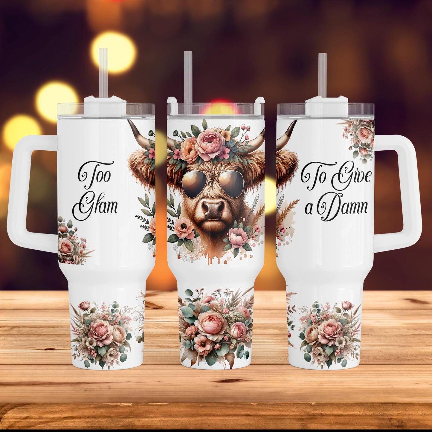 three travel mugs with a picture of a cow on them