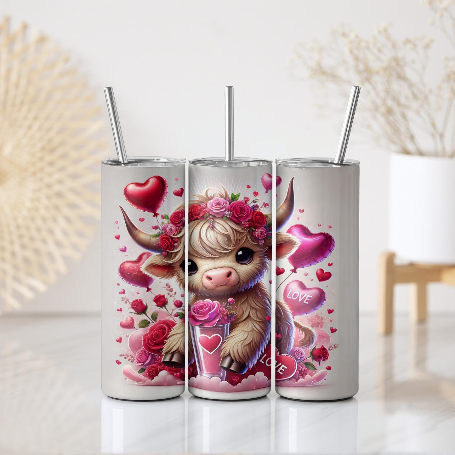 three tumbles with a cow and hearts on them