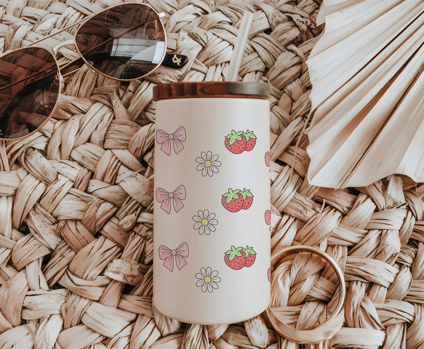 a straw hat, sunglasses, strawberries and a straw hat on a wicker