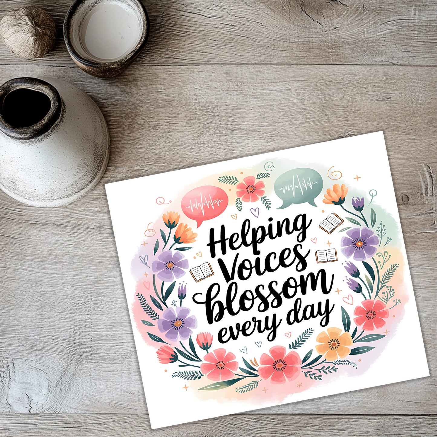 a colorful card with a floral wreath design and the text "Helping Voices Blossom Every Day" written on it.