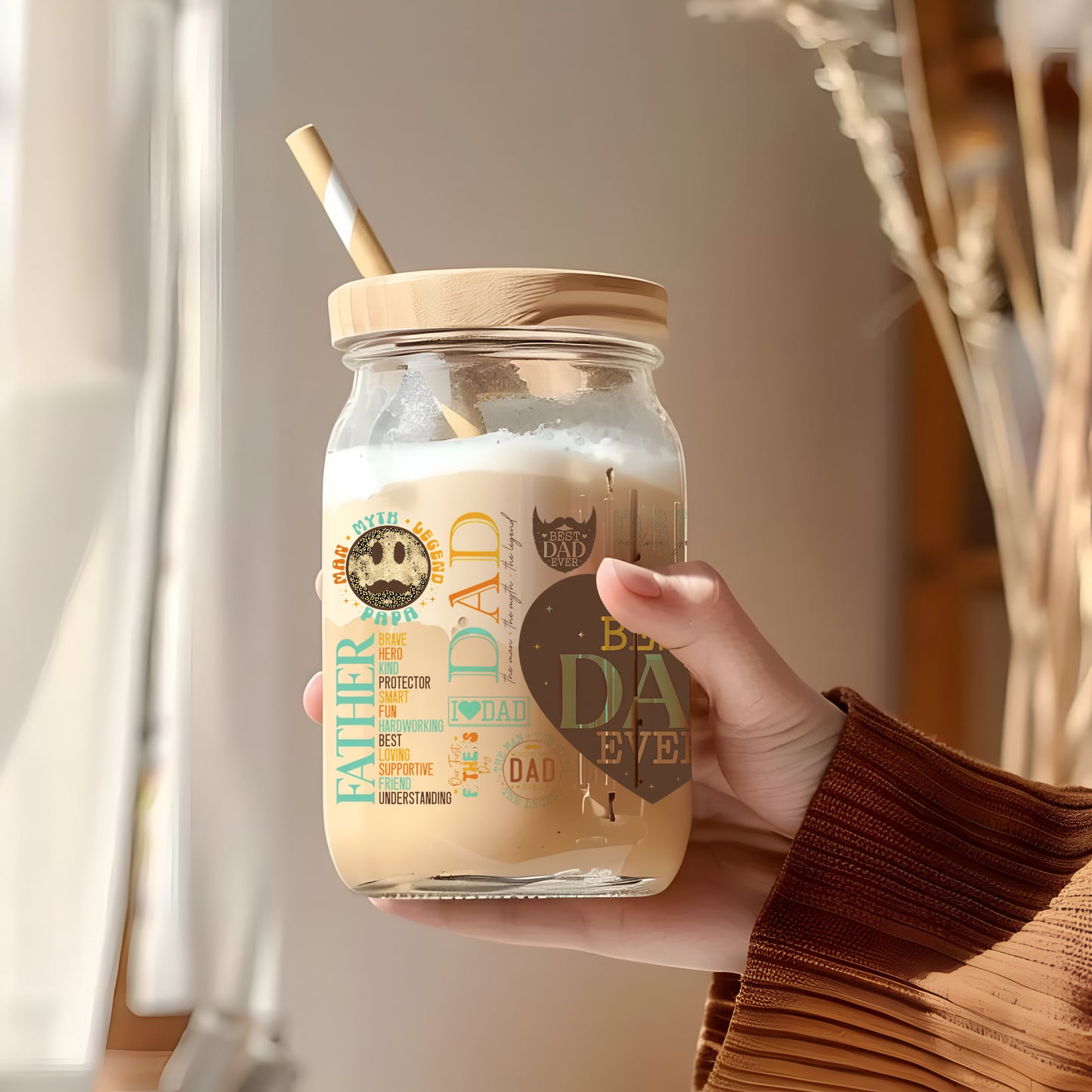 a person holding a mason jar with a straw in it