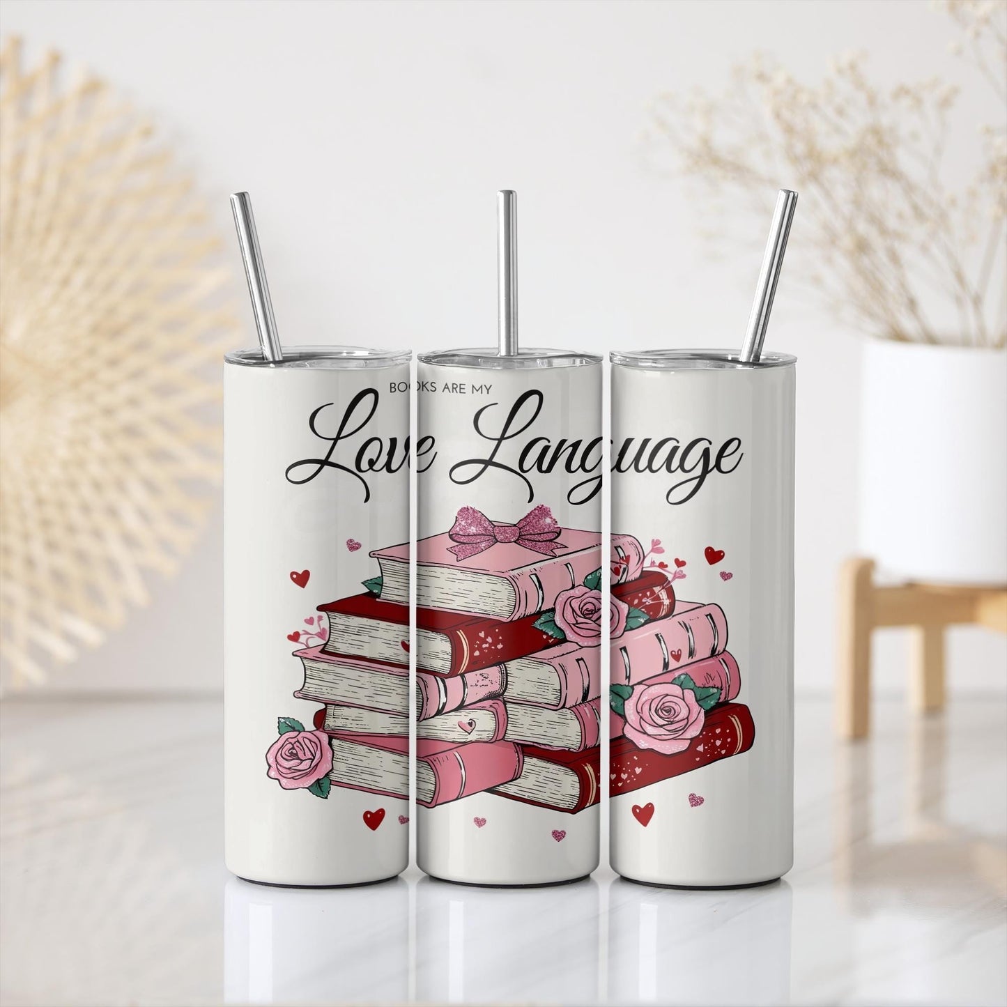 three cans of love language with books stacked on top of each other