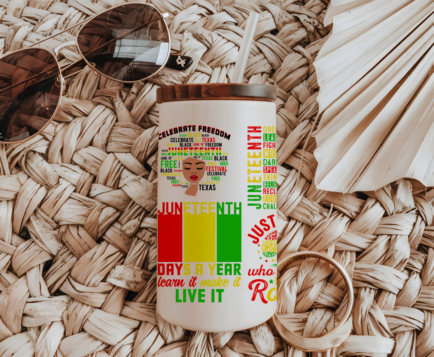 a coffee cup with a colorful design on it next to a pair of sunglasses