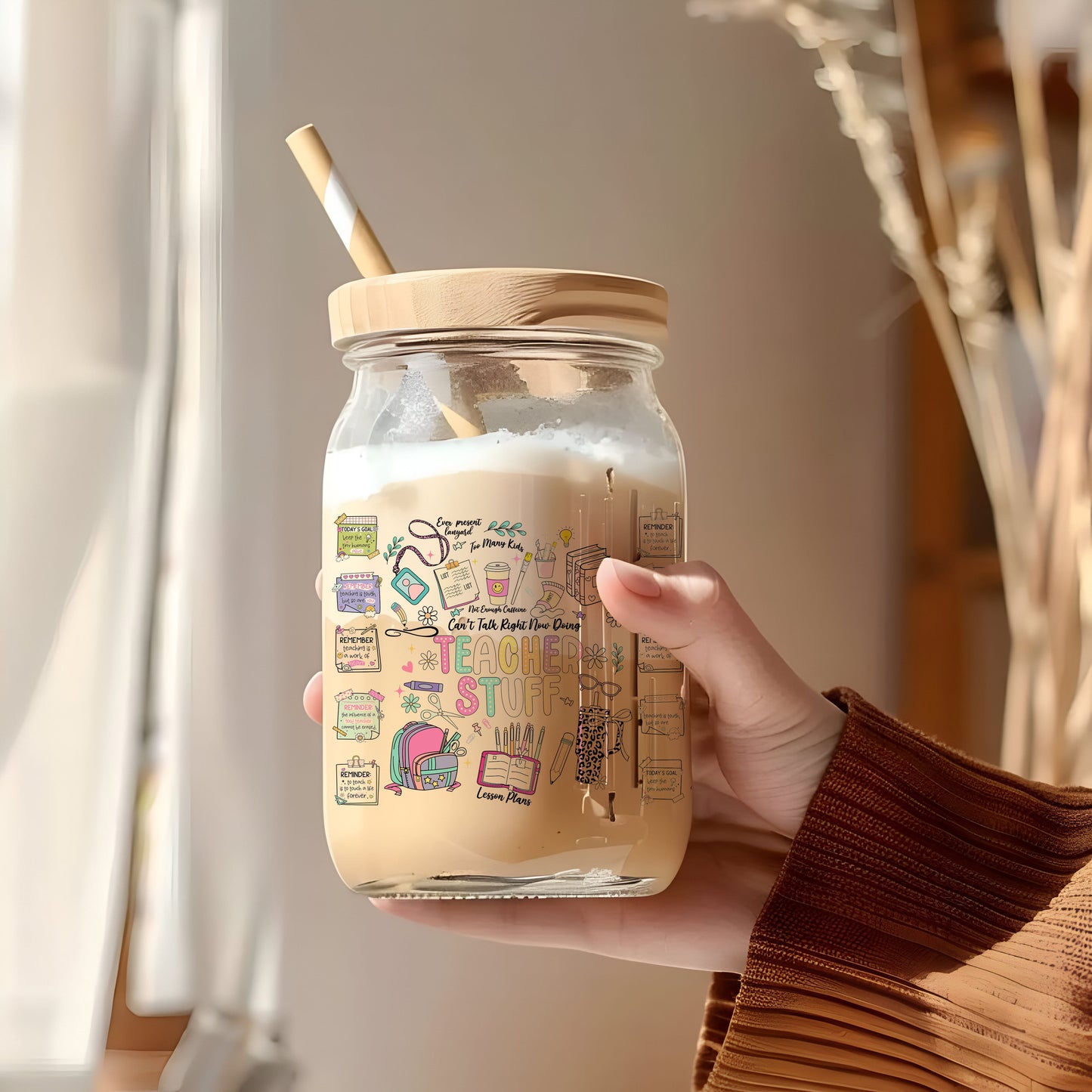 a person holding a jar with a straw in it
