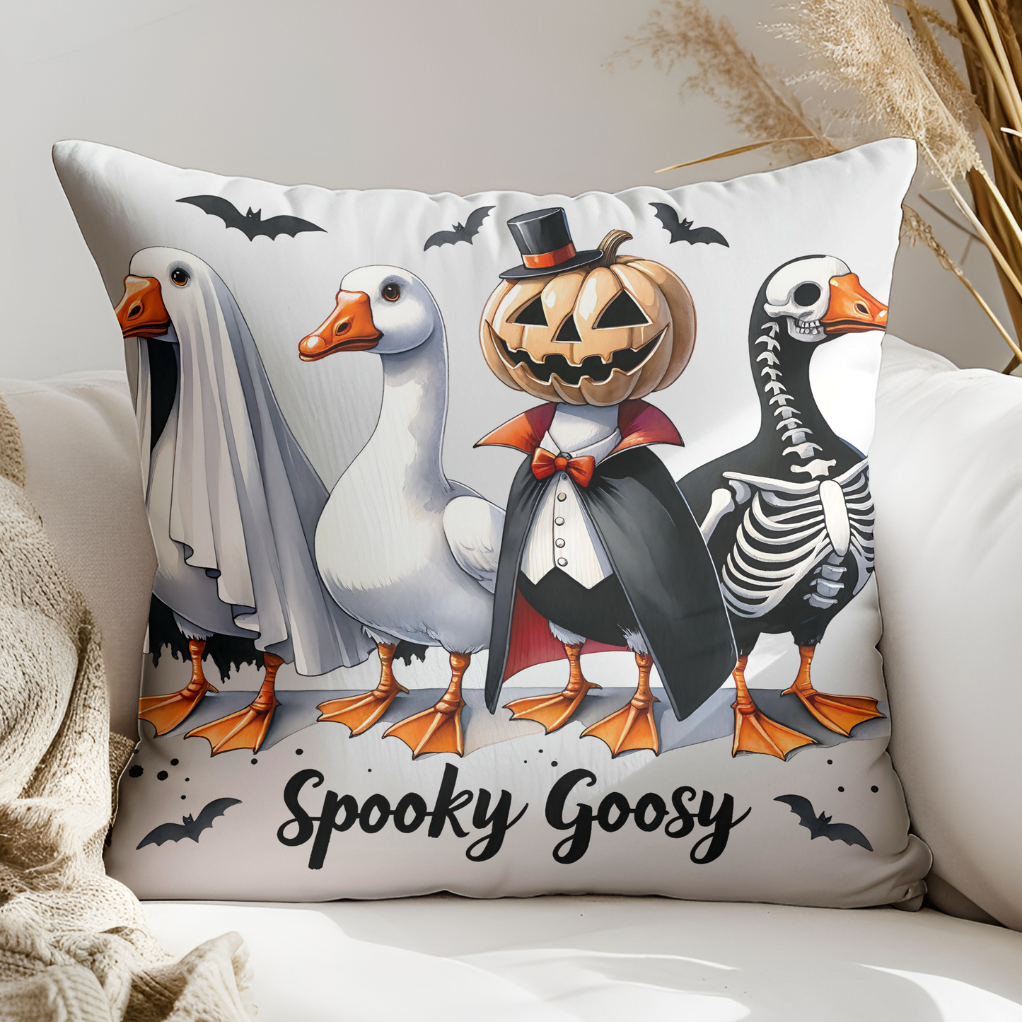 a white couch with a halloween pillow on it