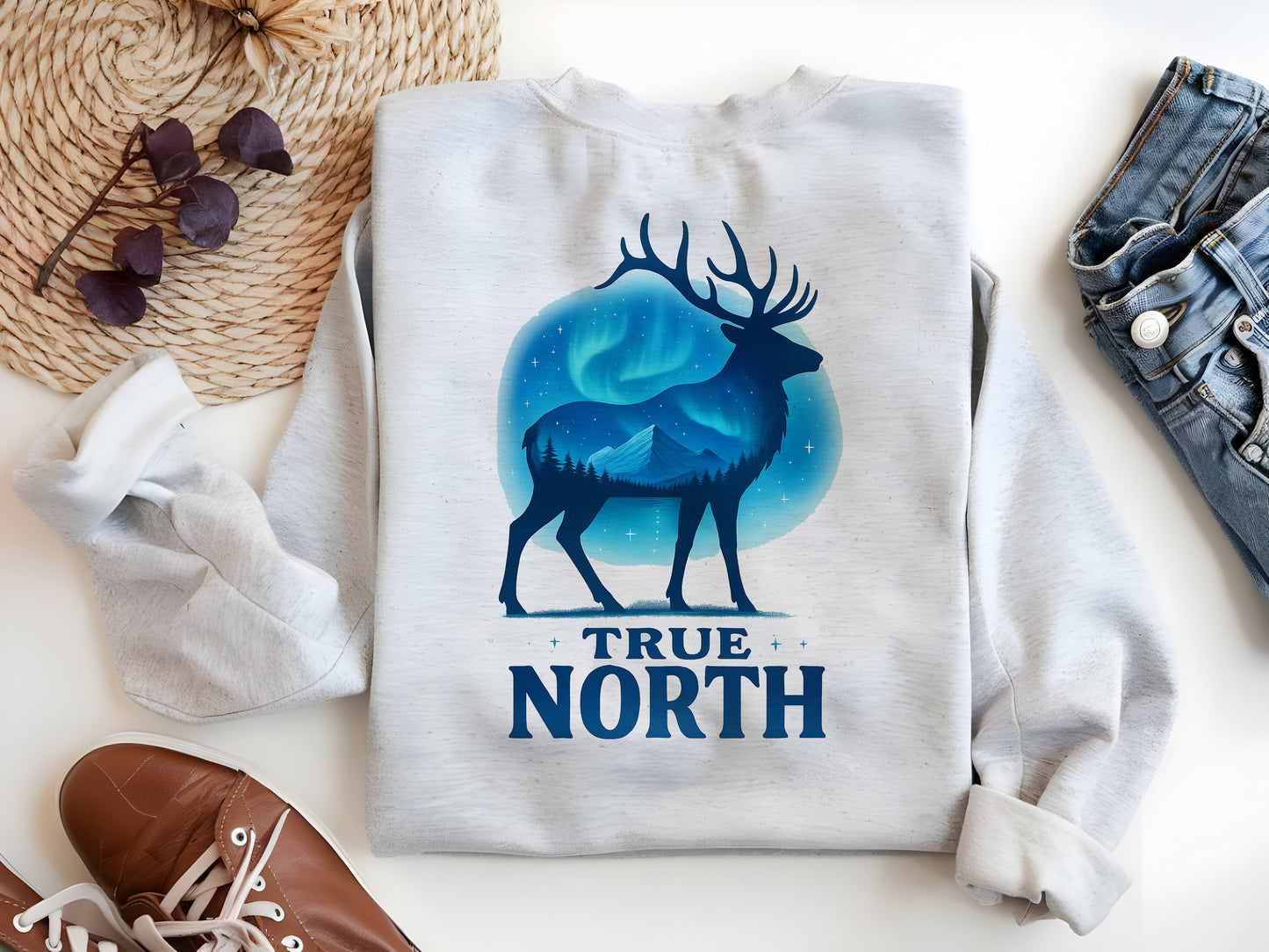 a white shirt with a deer and the words true north on it