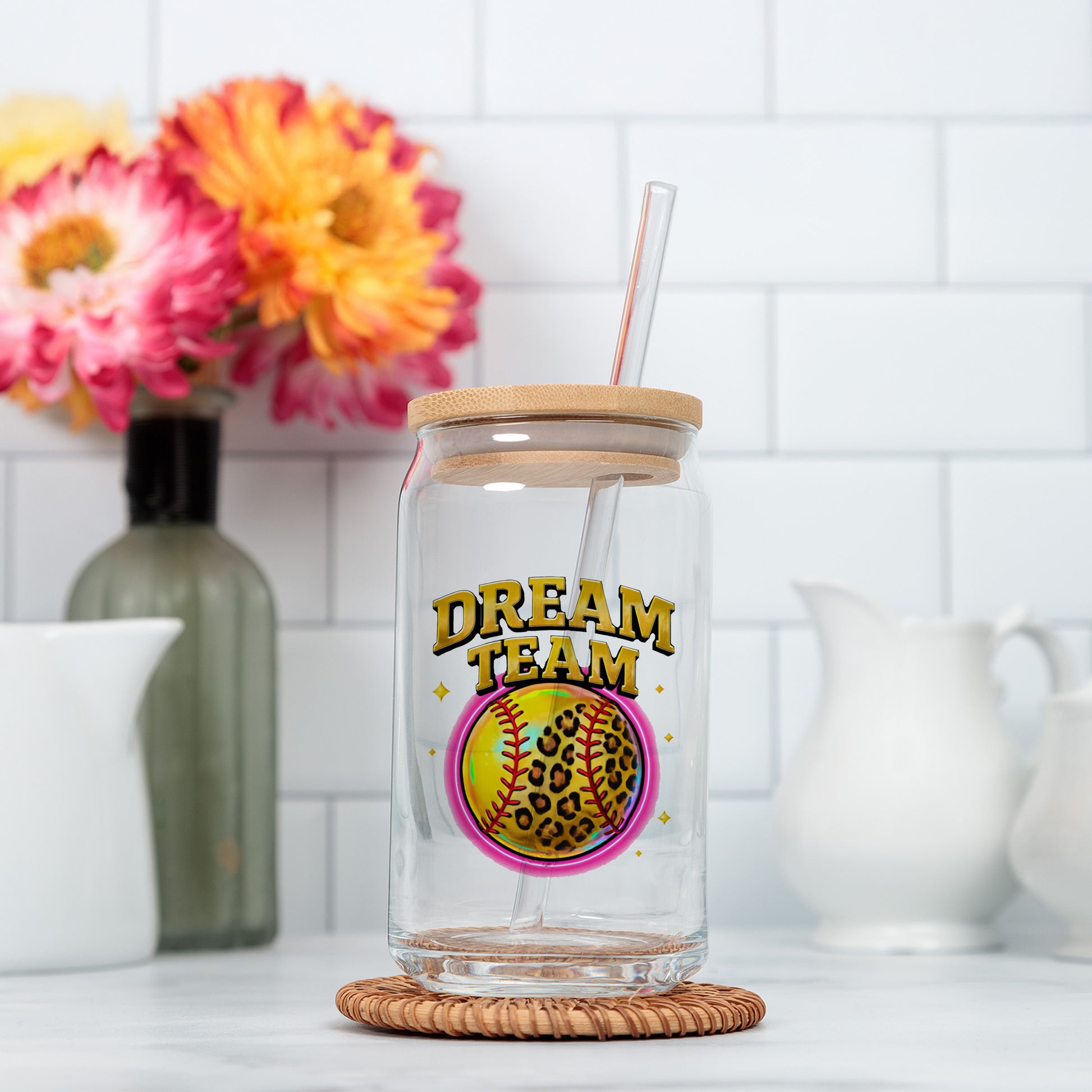 a glass jar with a straw in it sitting on a counter