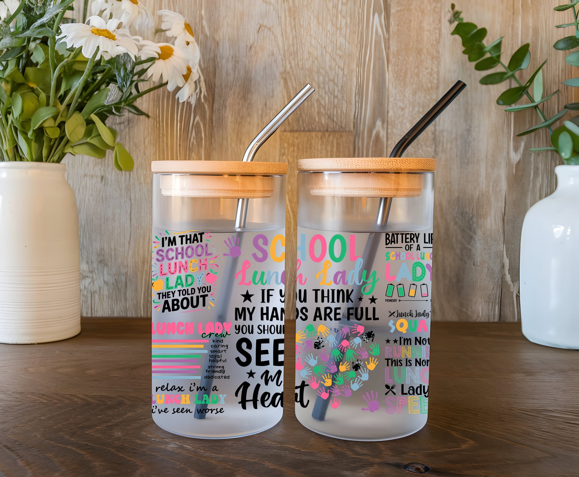 a couple of glass cups sitting on top of a wooden table