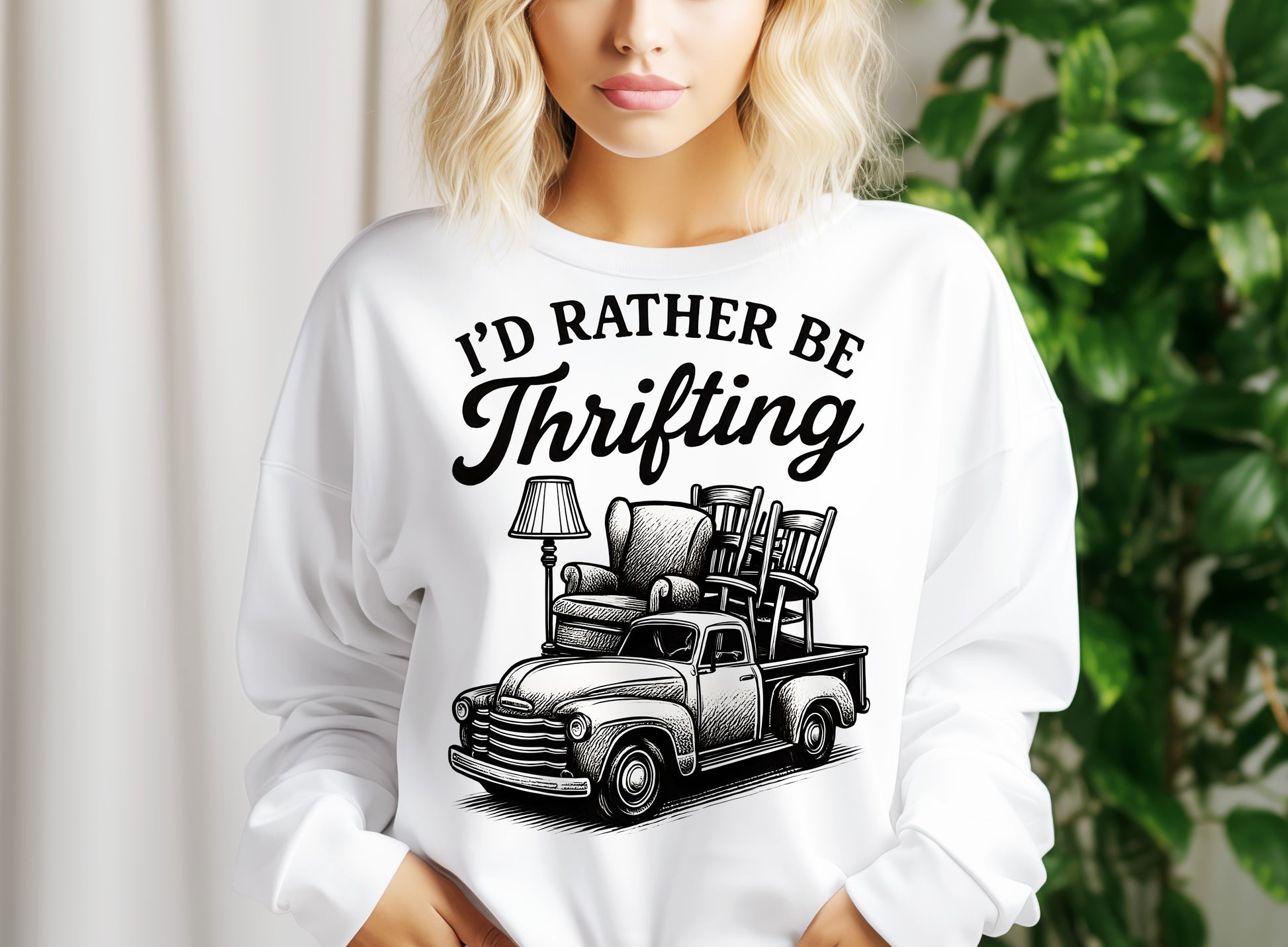 a woman wearing a white sweatshirt with a black graphic of a truck