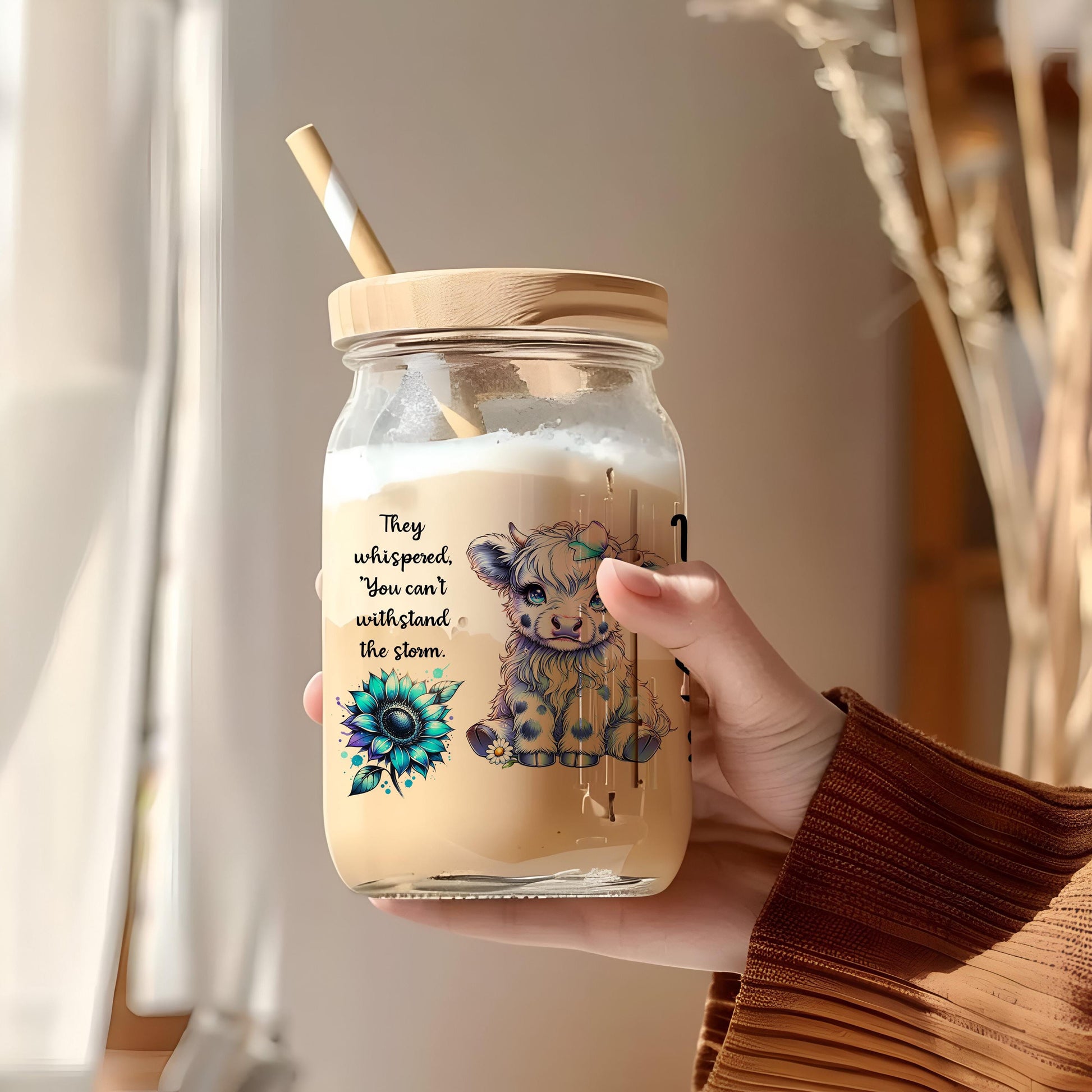 a person holding a jar with a straw in it