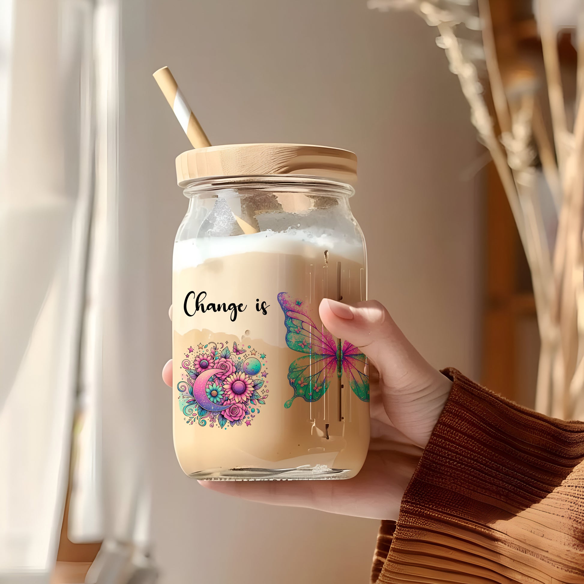 a person holding a jar with a straw in it