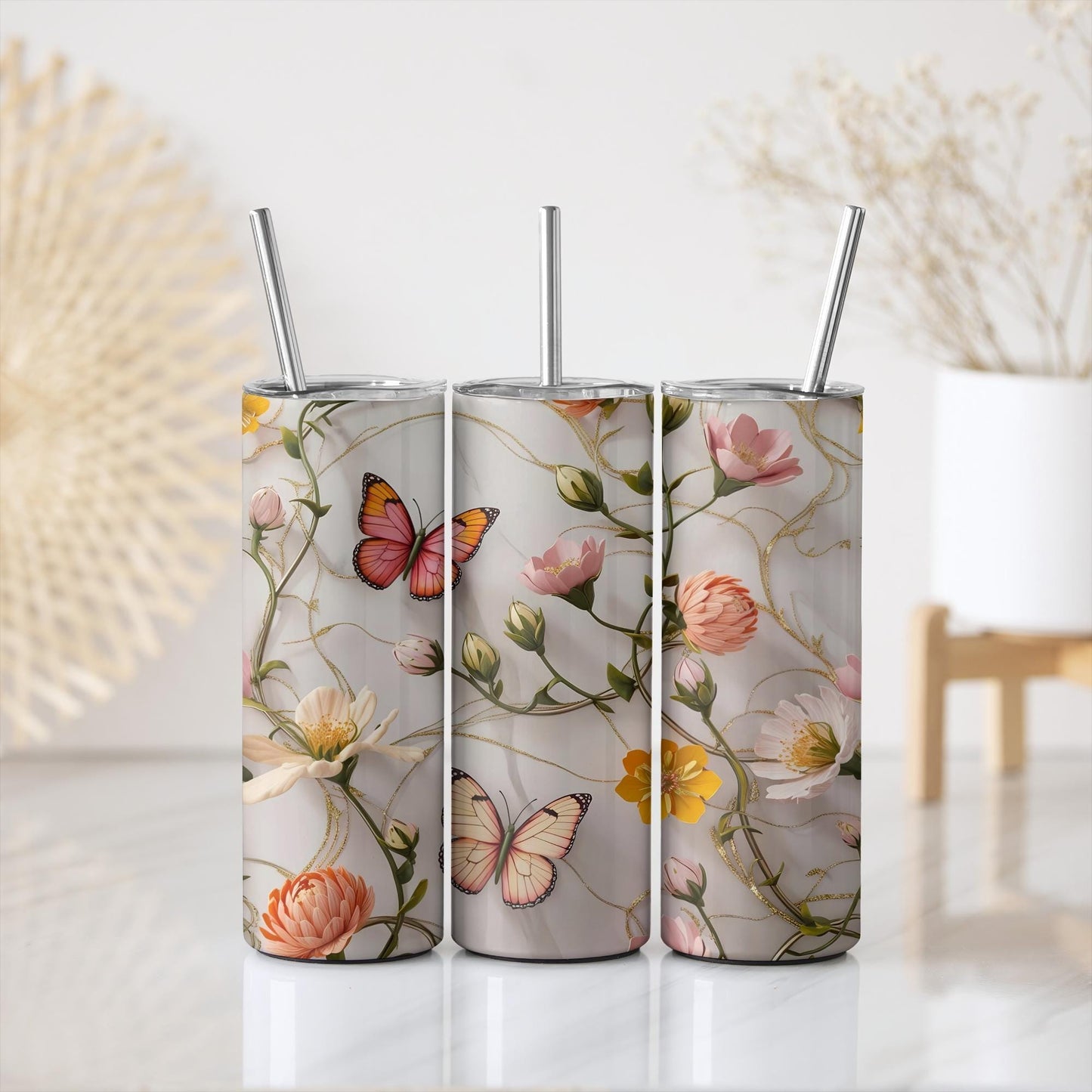 a set of three tumbles with butterflies and flowers on them