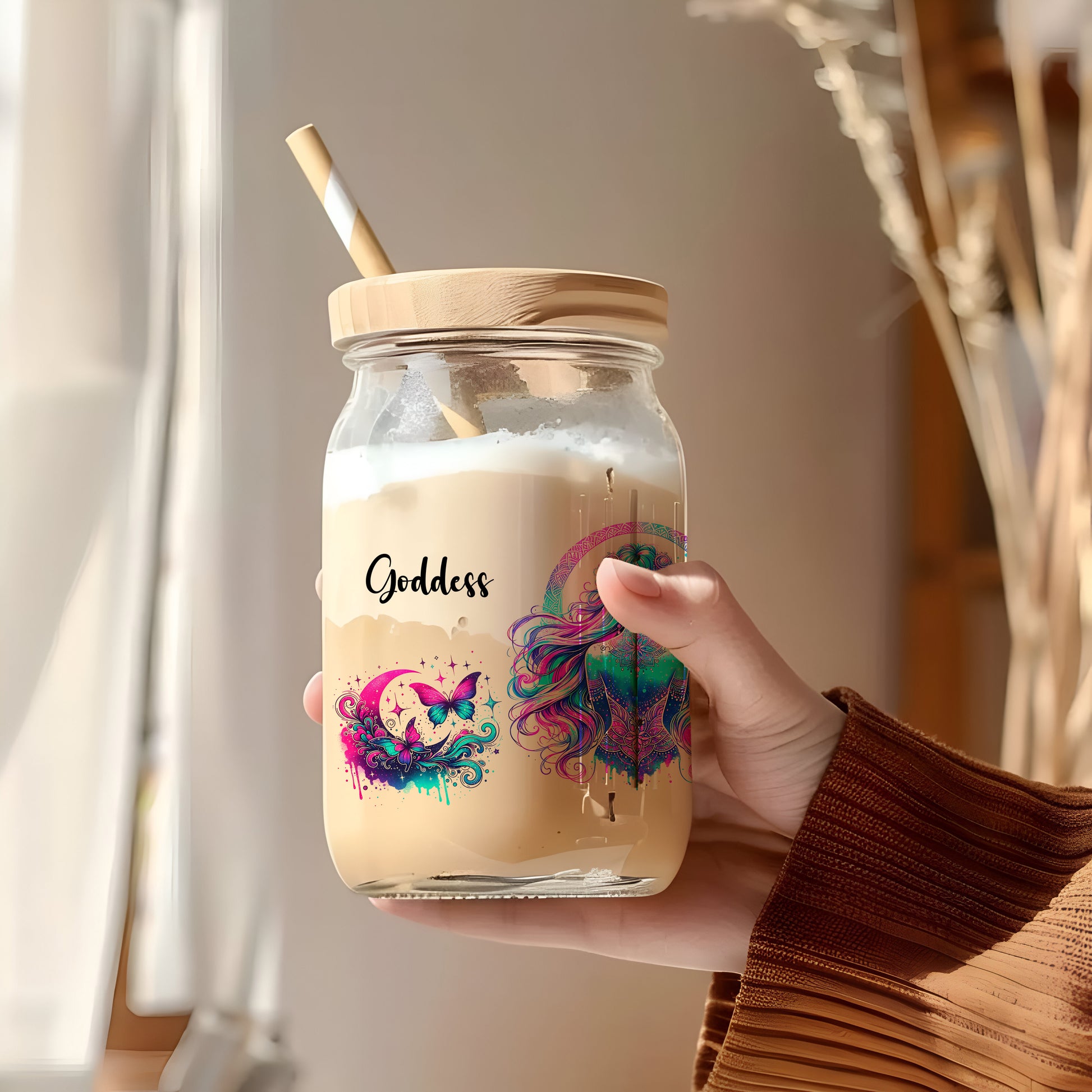 a person holding a jar with a straw in it