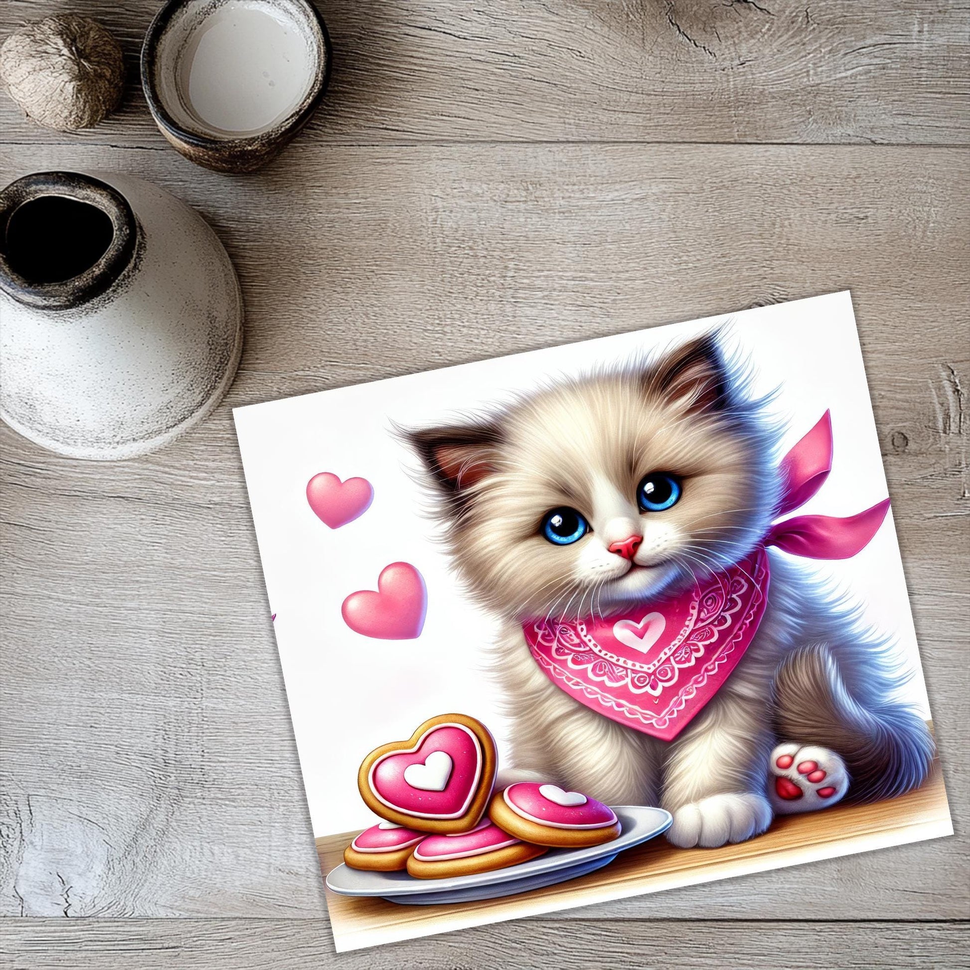 a painting of a kitten with a pink scarf