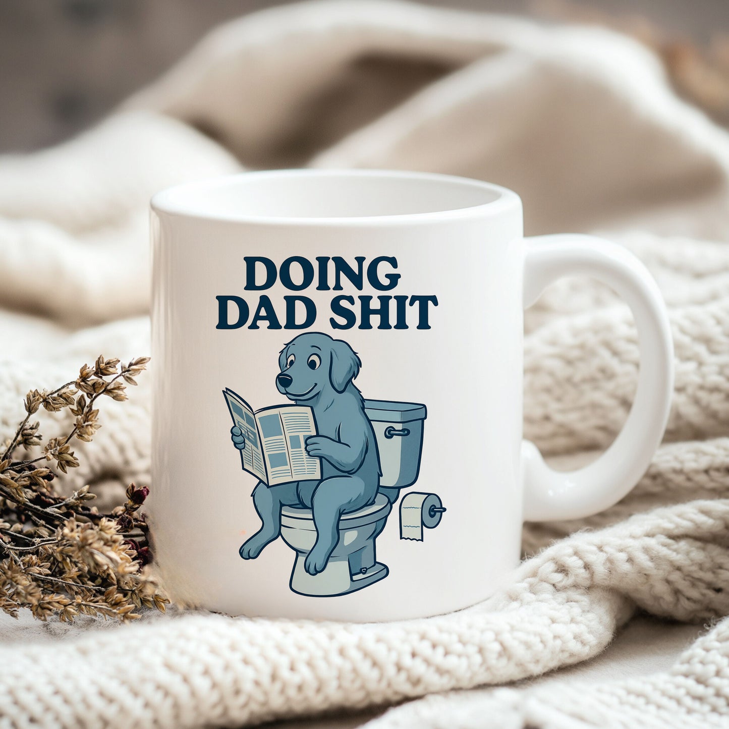 a coffee mug sitting on top of a white blanket