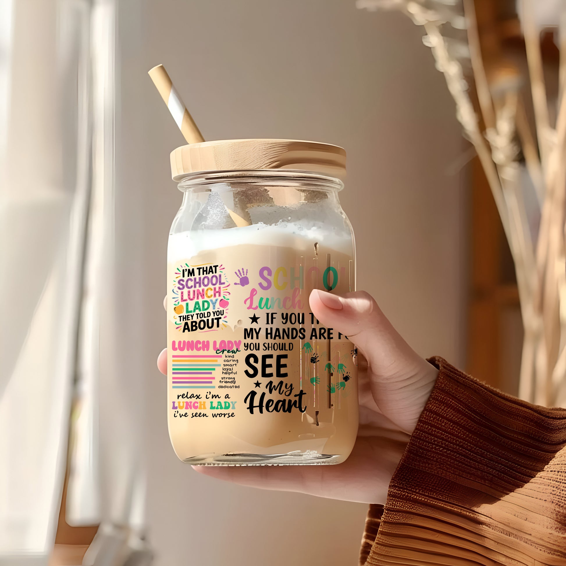 a person holding a jar with a straw in it