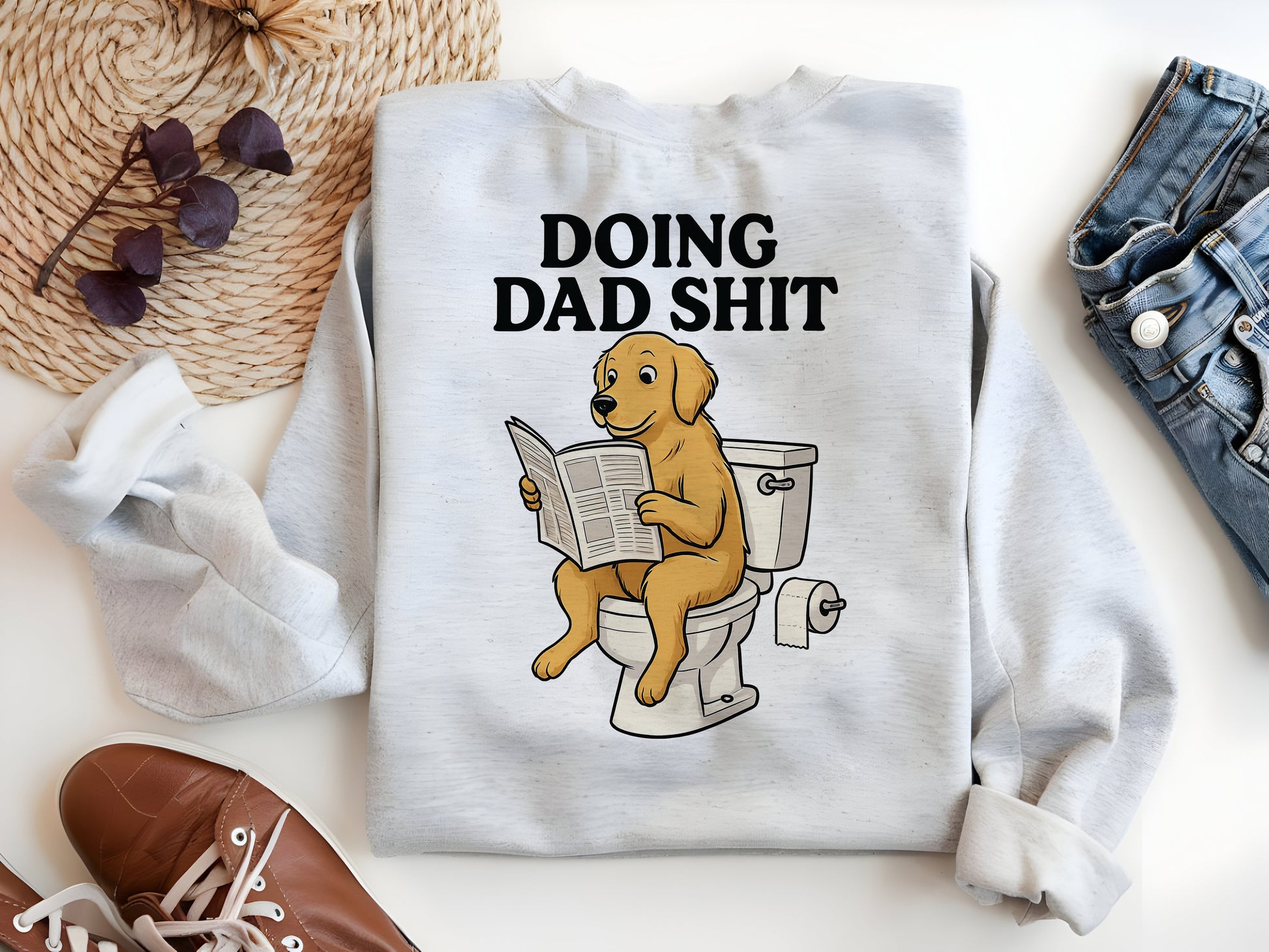 a white shirt with a dog sitting on a toilet reading a newspaper