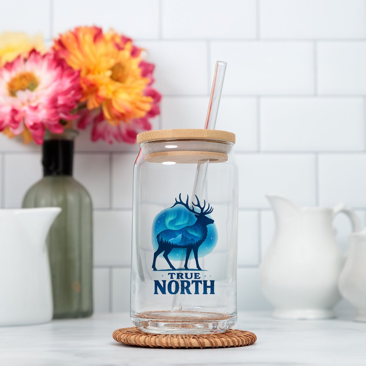 a glass with a straw in it sitting on a counter