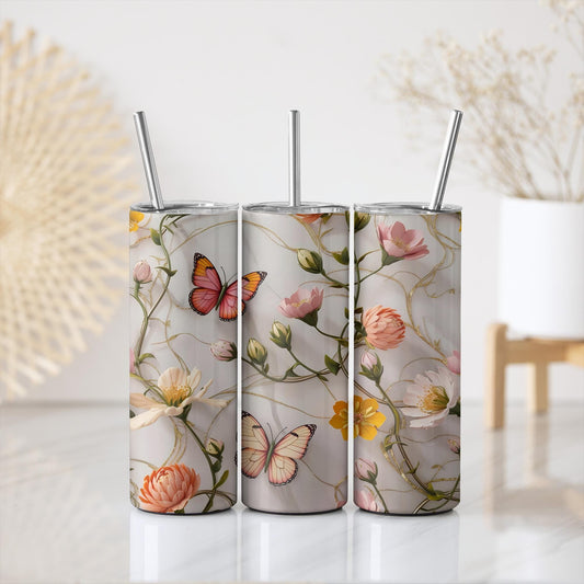a set of three tumbles with butterflies and flowers on them