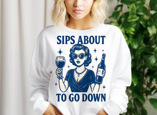 a woman holding a glass of wine wearing a sweatshirt