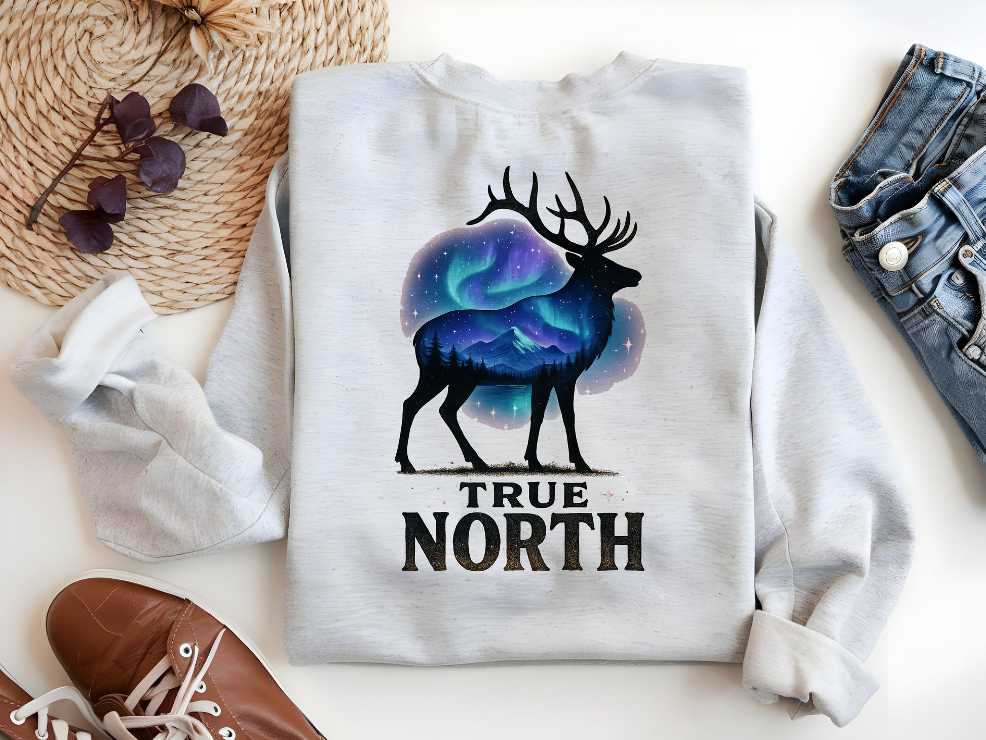 a white shirt with a picture of a deer and the words true north on it