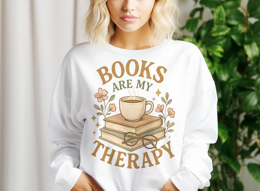a woman wearing a sweatshirt that says books are my therapy