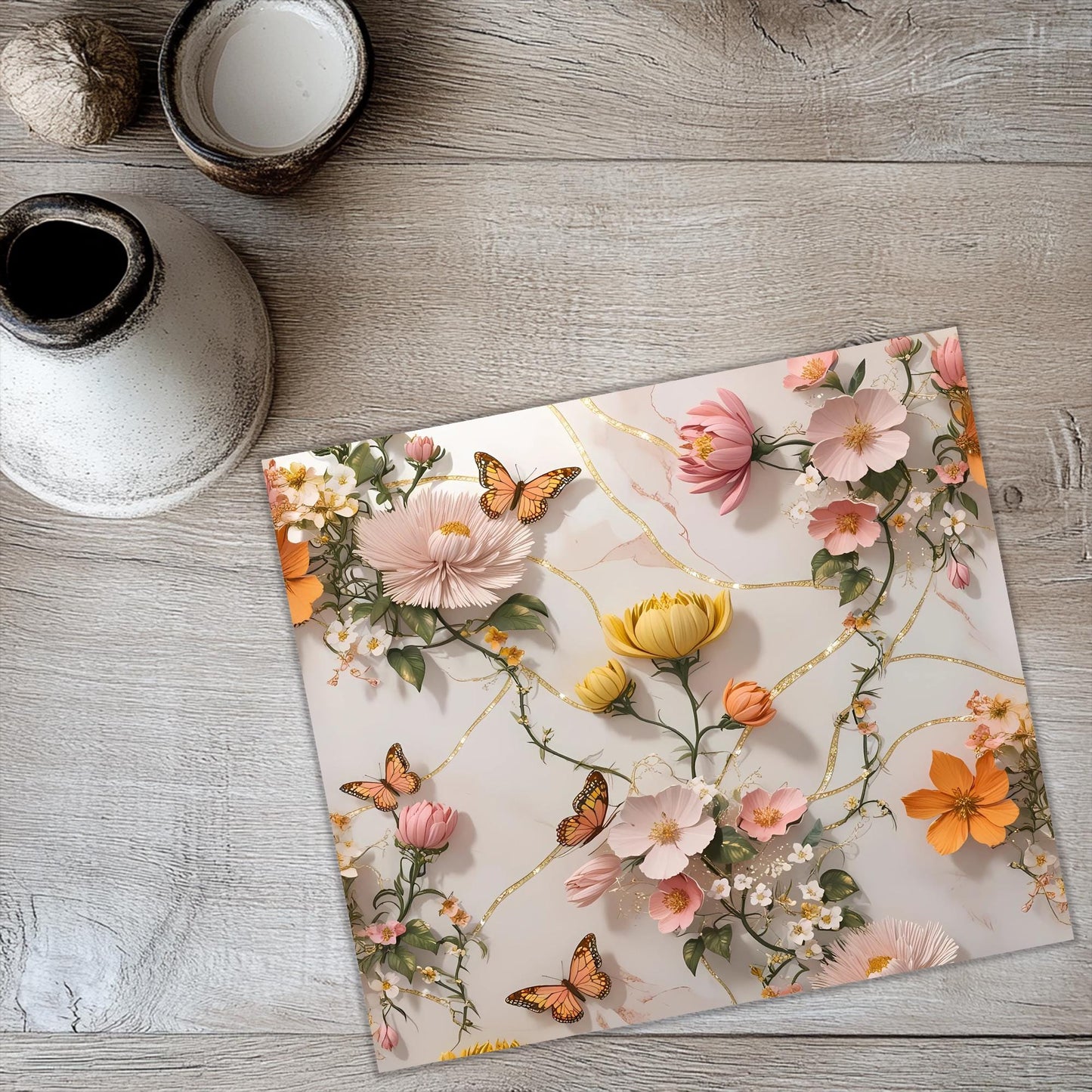 a picture of flowers and butterflies on a table
