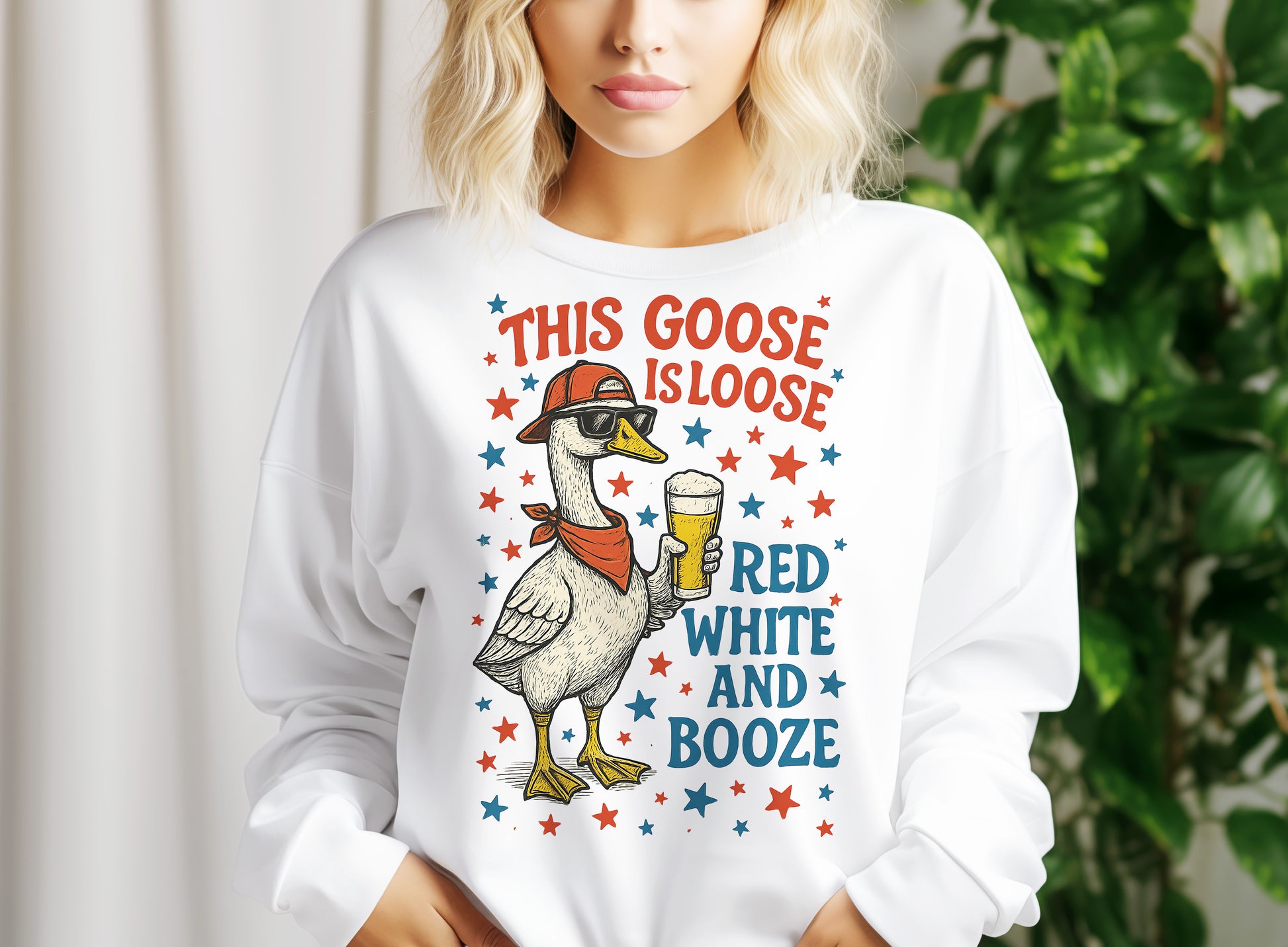 a woman wearing a white shirt that says, this goose is loose and booze