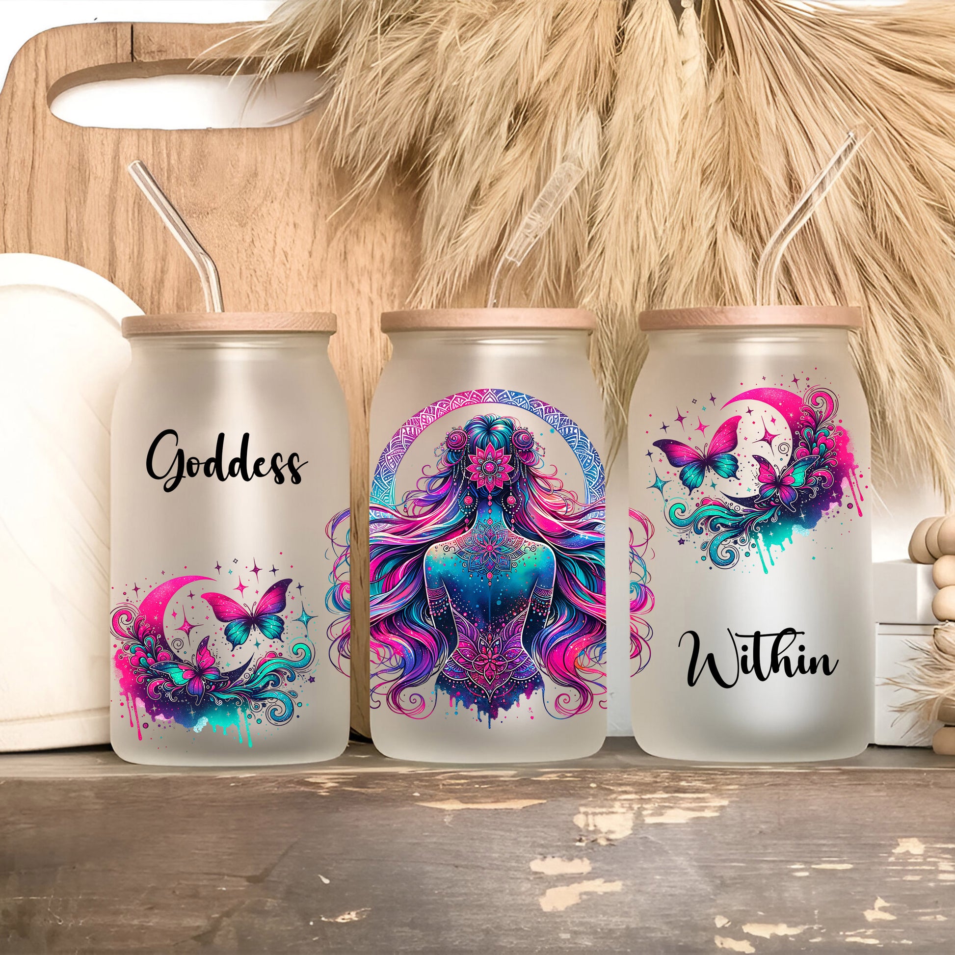 three water bottles with designs on them sitting on a shelf