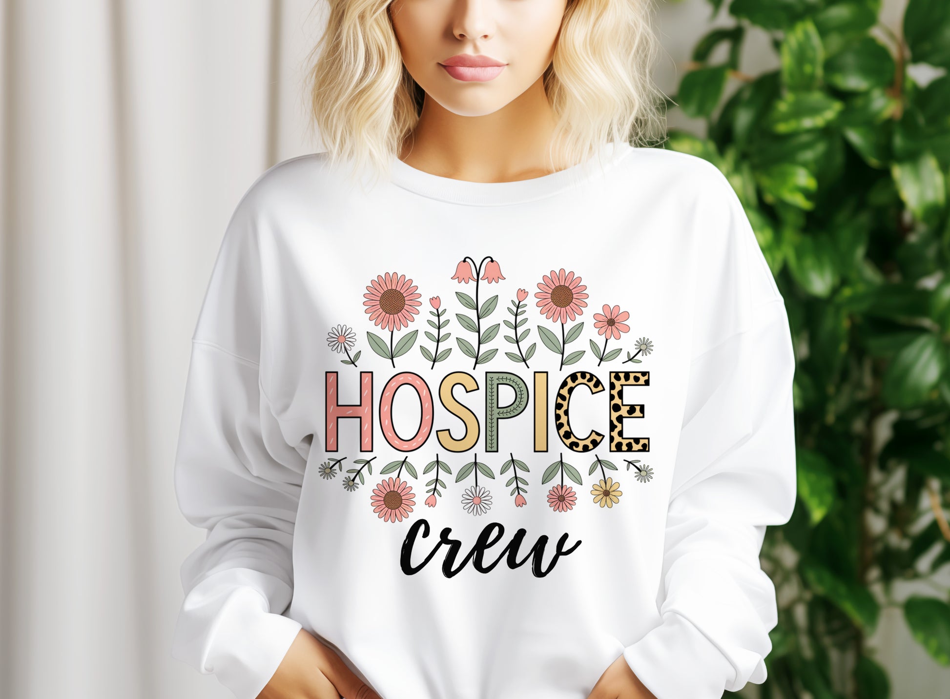 a woman wearing a white sweatshirt that says hospice crew