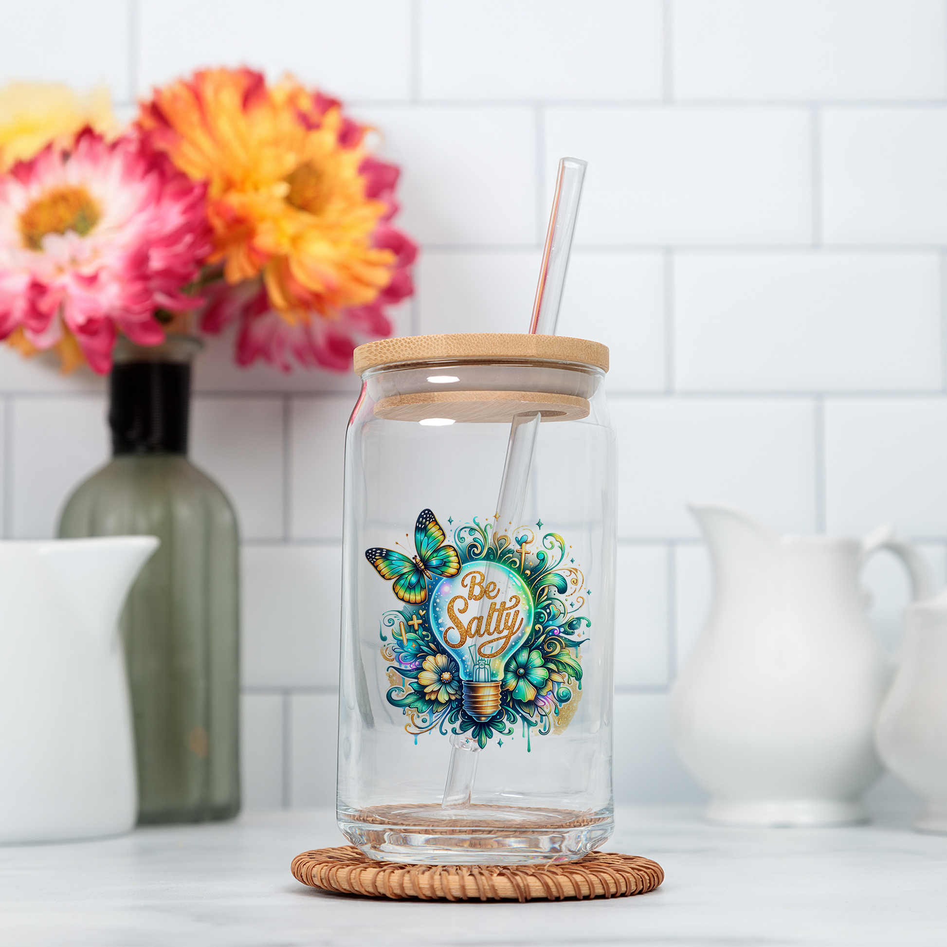 a glass jar with a straw in it sitting on a counter