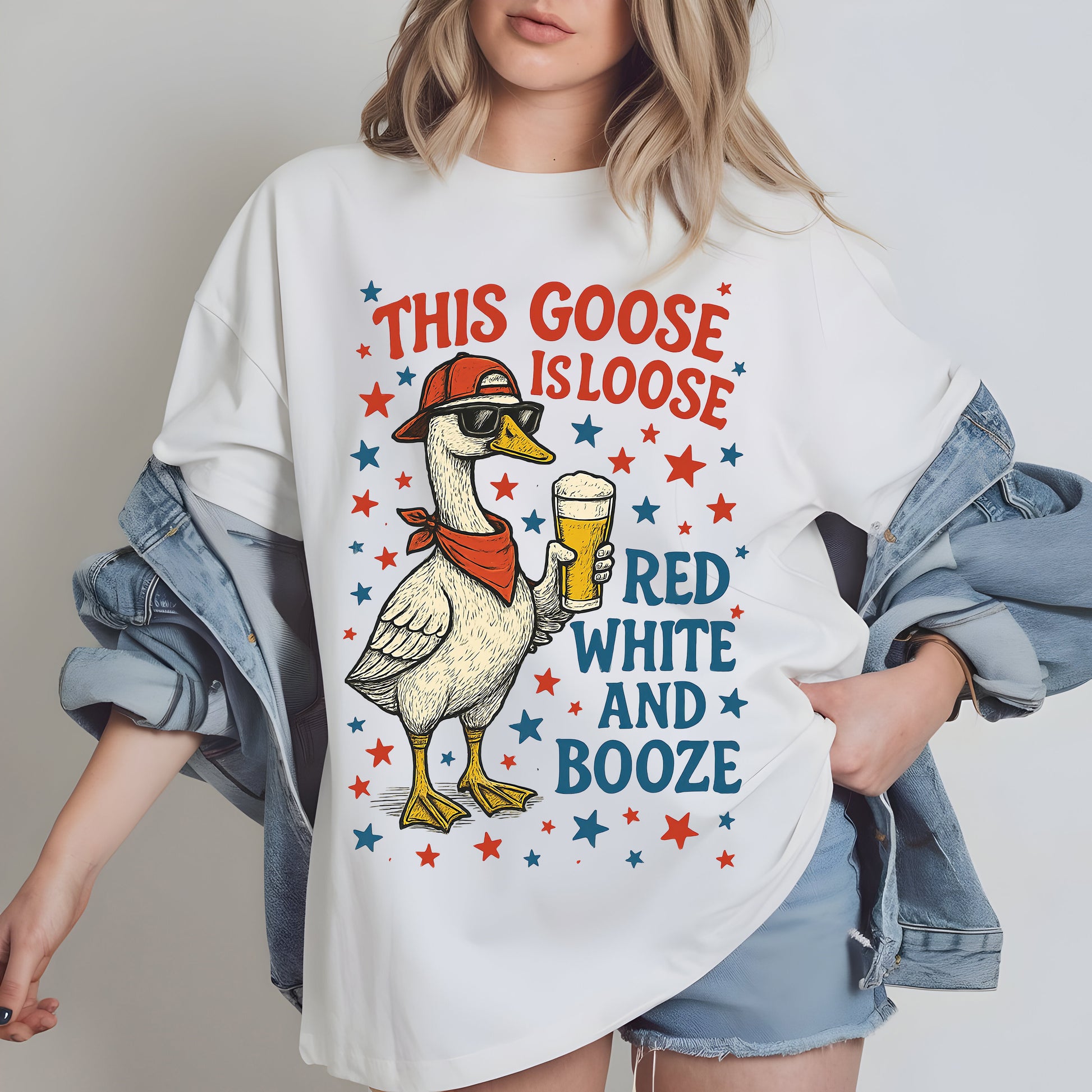a woman wearing a white goose t - shirt with red, white and booze