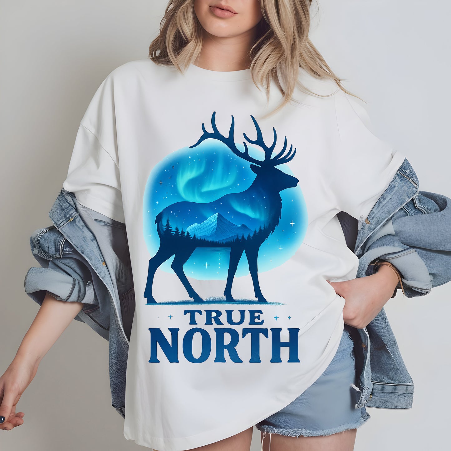 a woman wearing a white t - shirt with an image of a deer and the