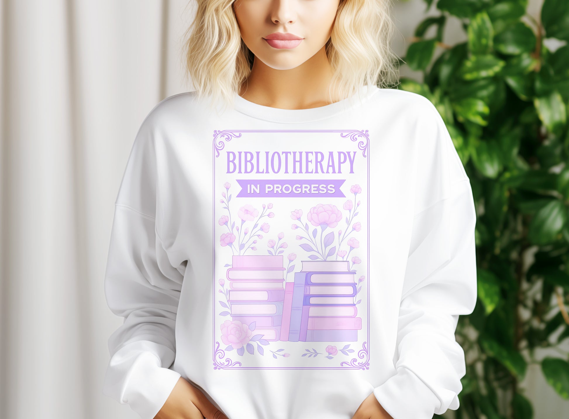 a woman wearing a white sweatshirt with the words bibliotherap in progress