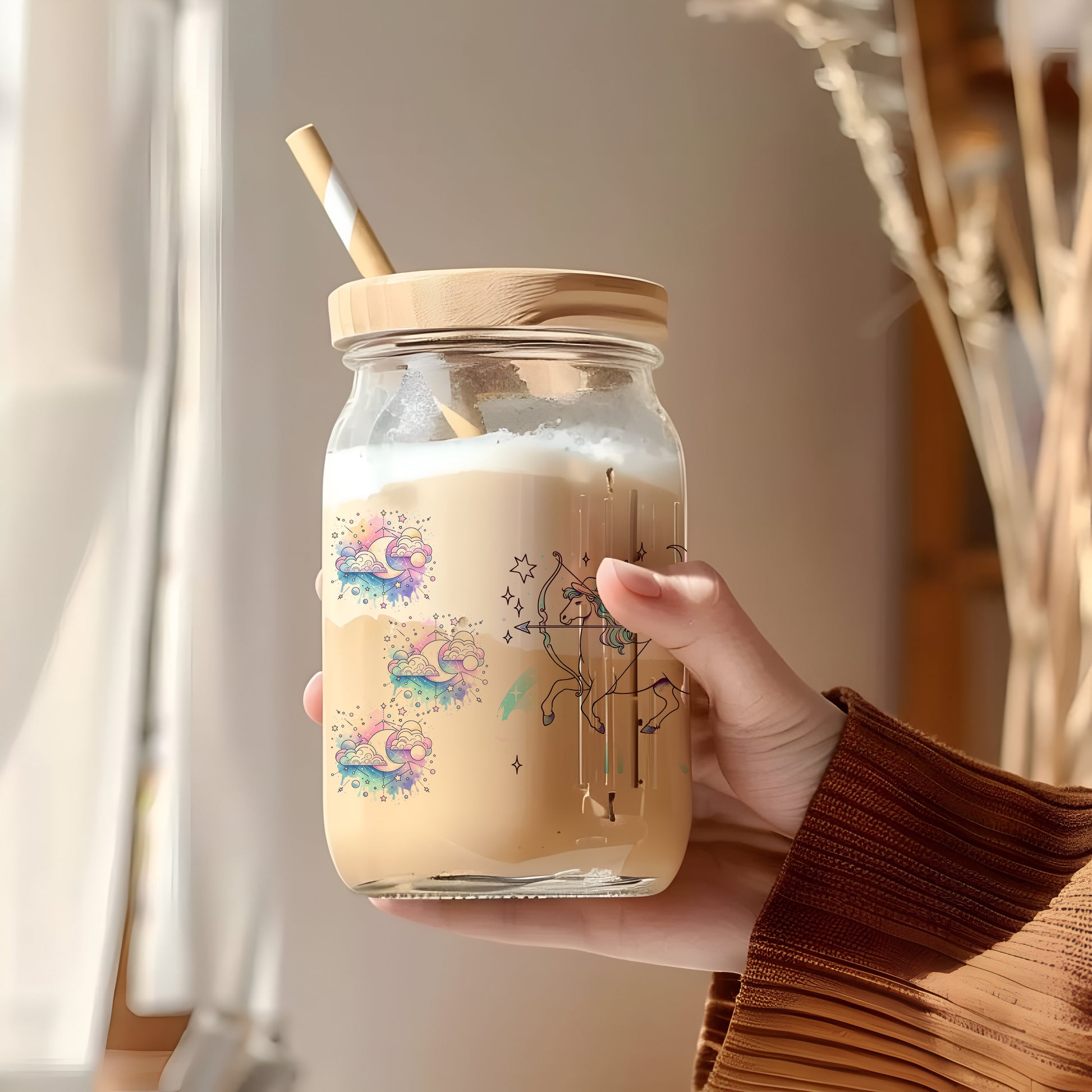 a person holding a jar with a straw in it