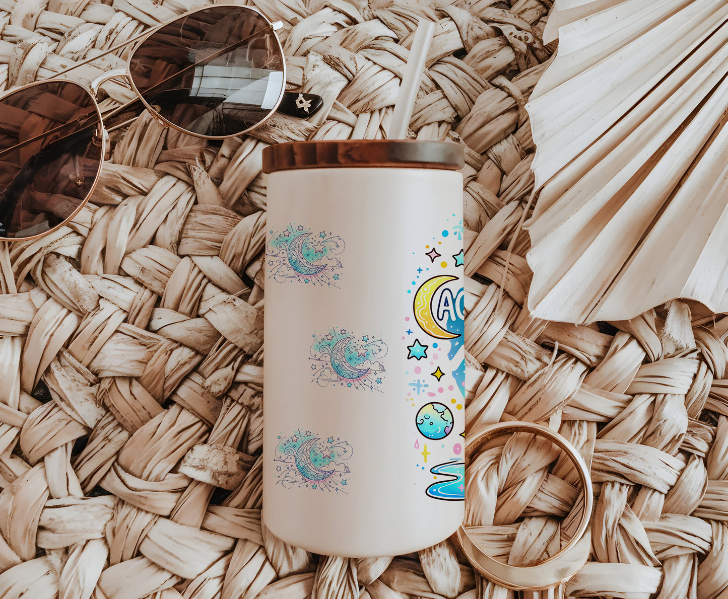 a white coffee cup sitting on top of a table next to sunglasses
