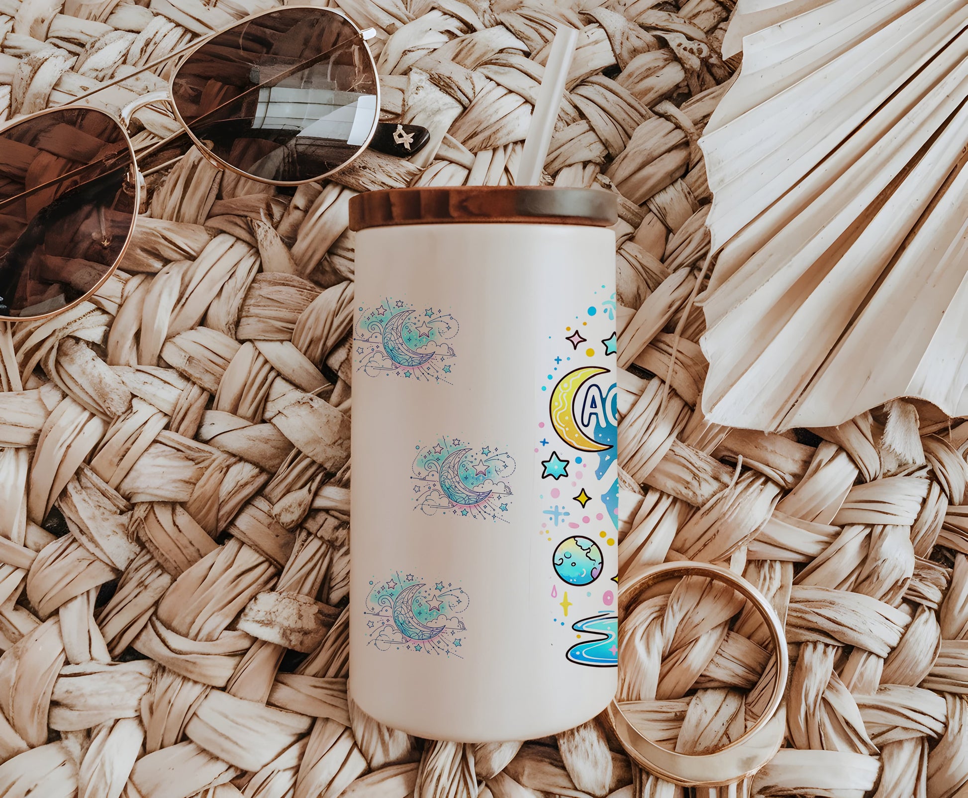 a white coffee cup sitting on top of a table next to sunglasses