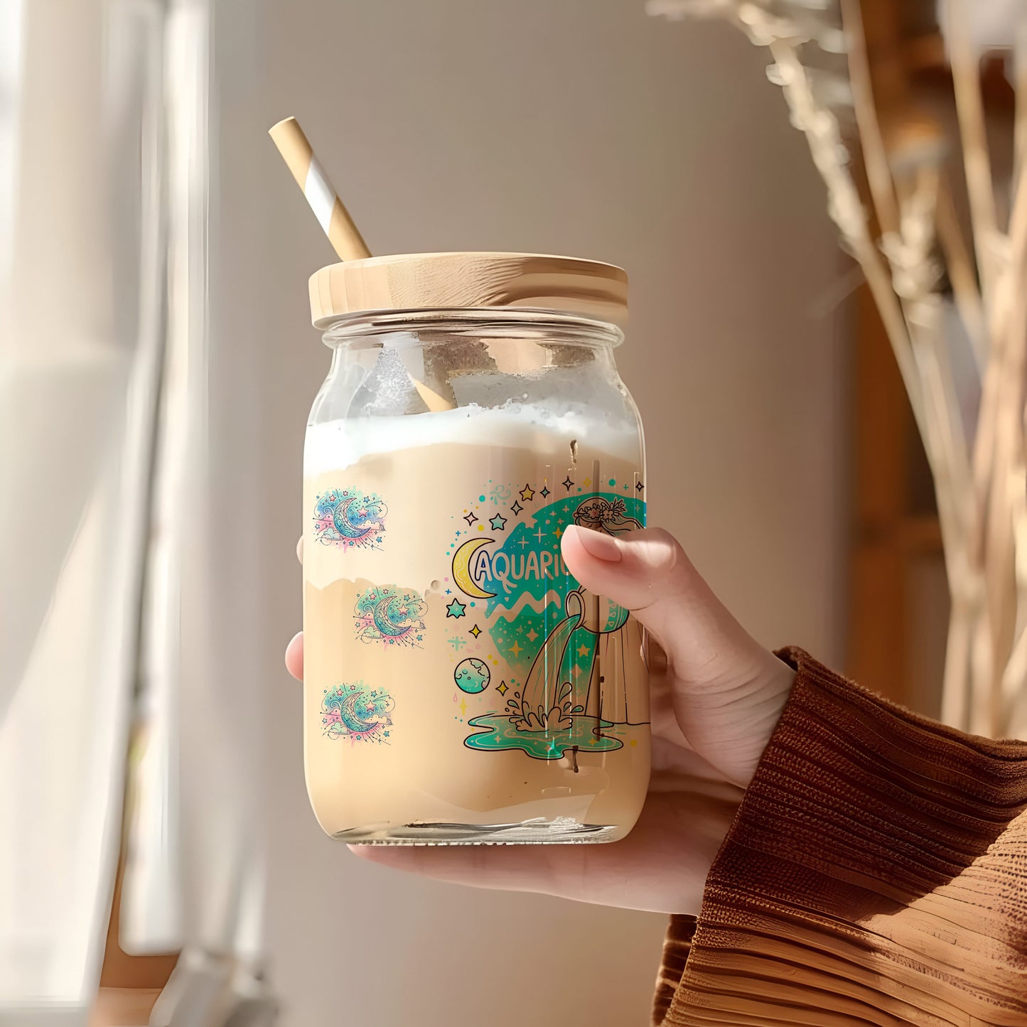a person holding a jar with a straw in it