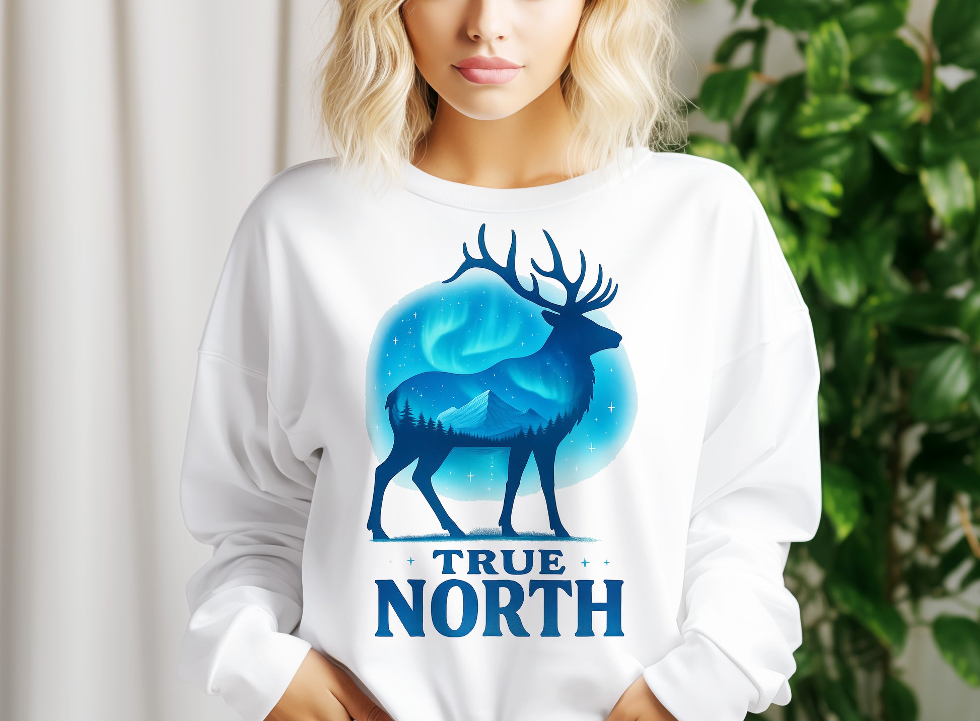 a woman wearing a white shirt with a deer graphic on it