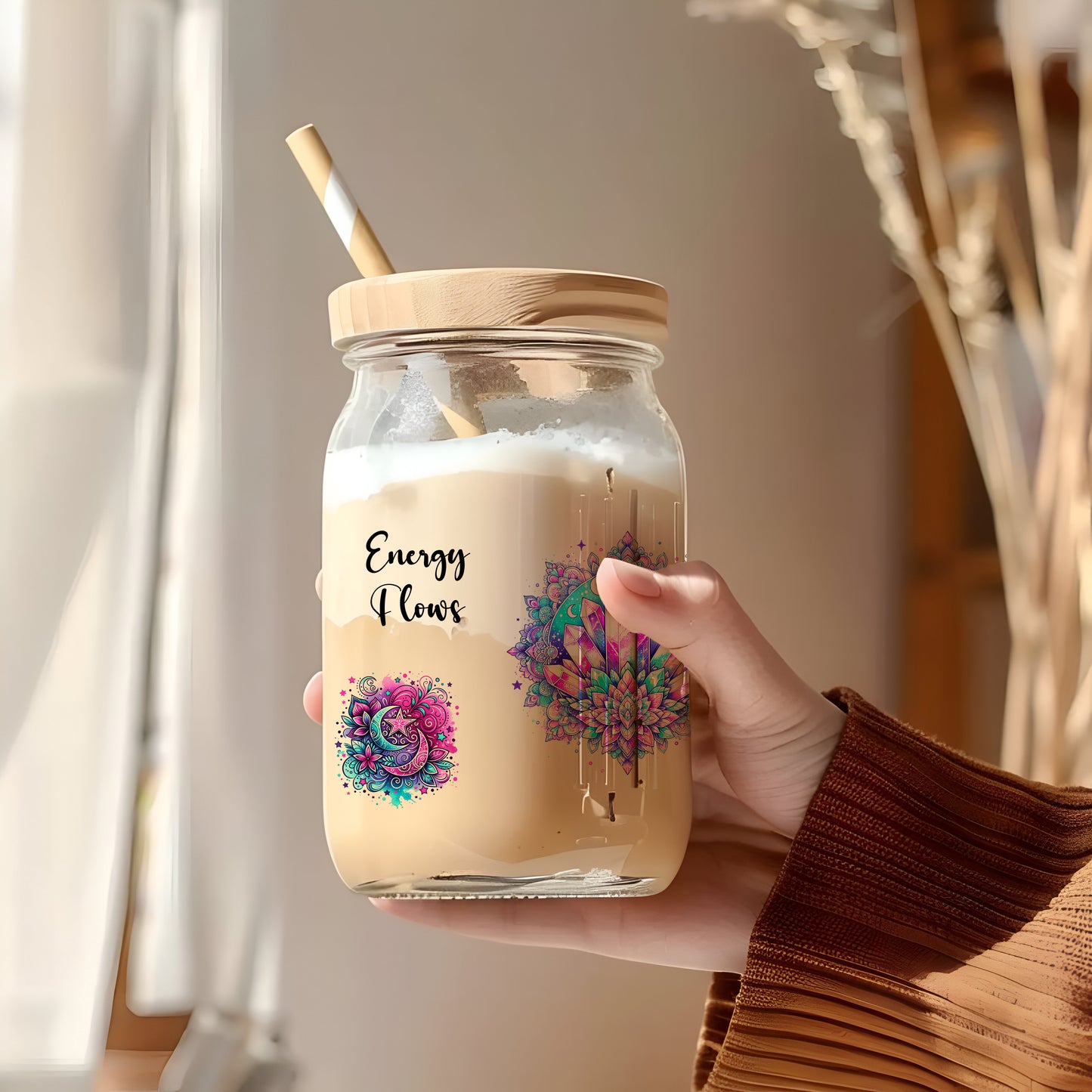 a person holding a jar with a straw in it