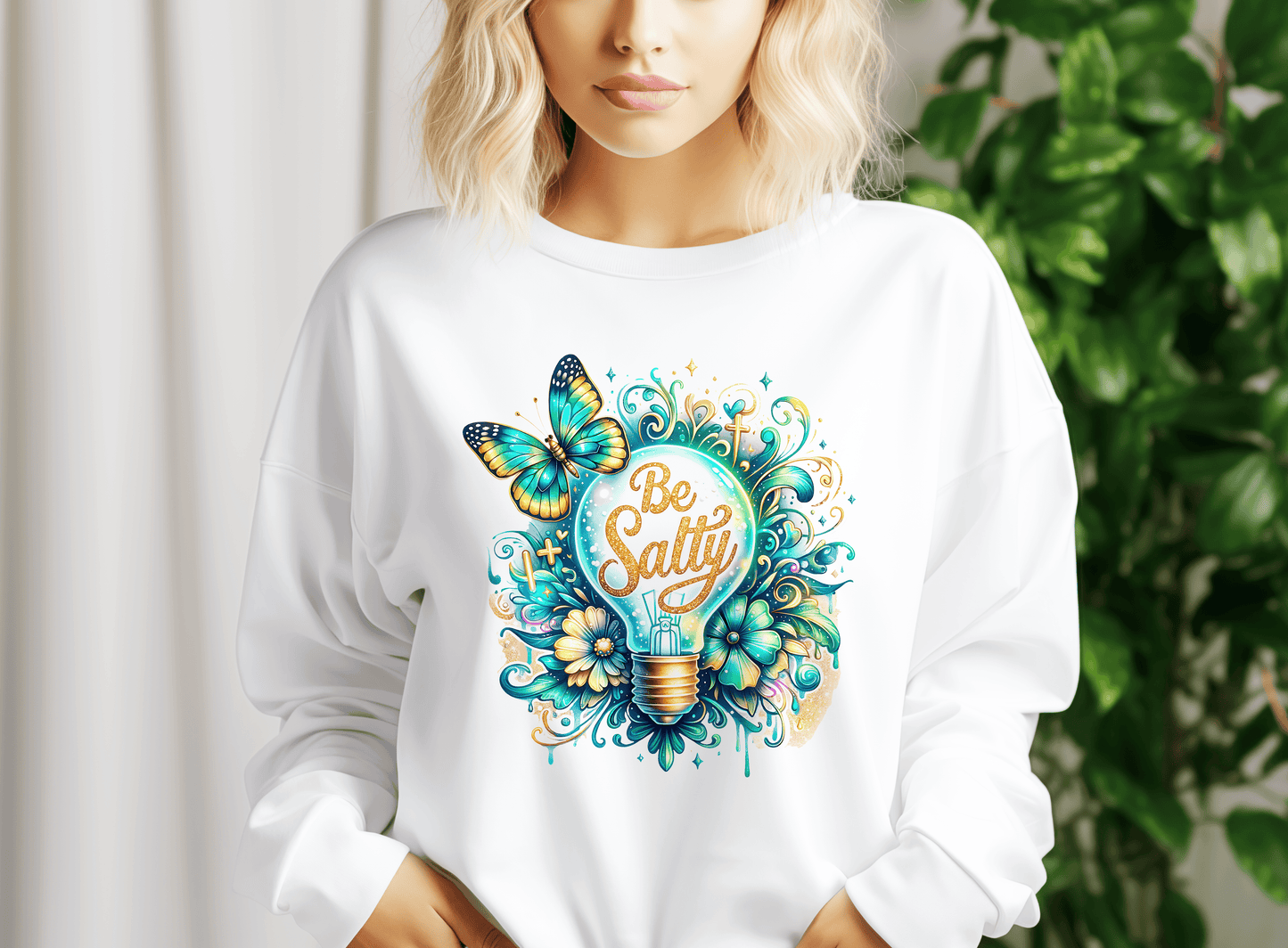 a woman wearing a white sweatshirt with the words be salty on it