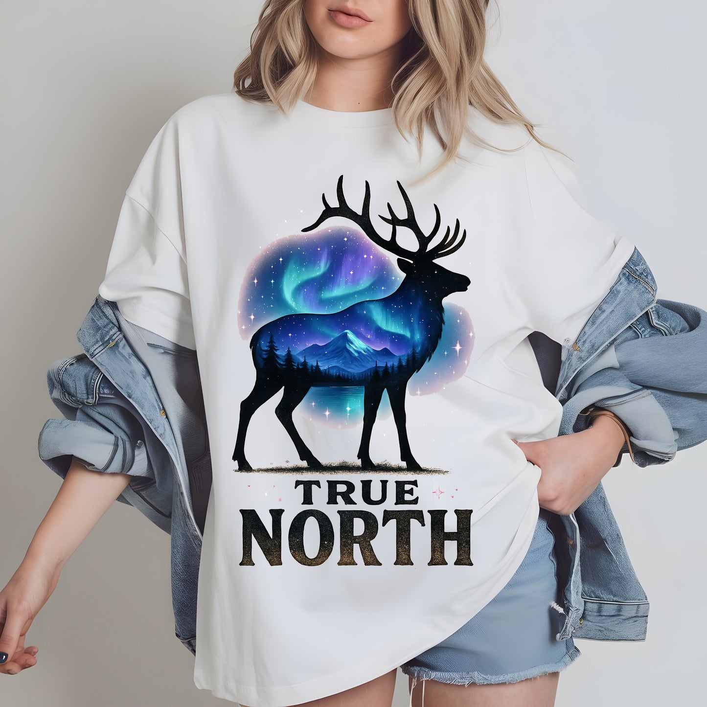 a woman wearing a white t - shirt with the words true north printed on it