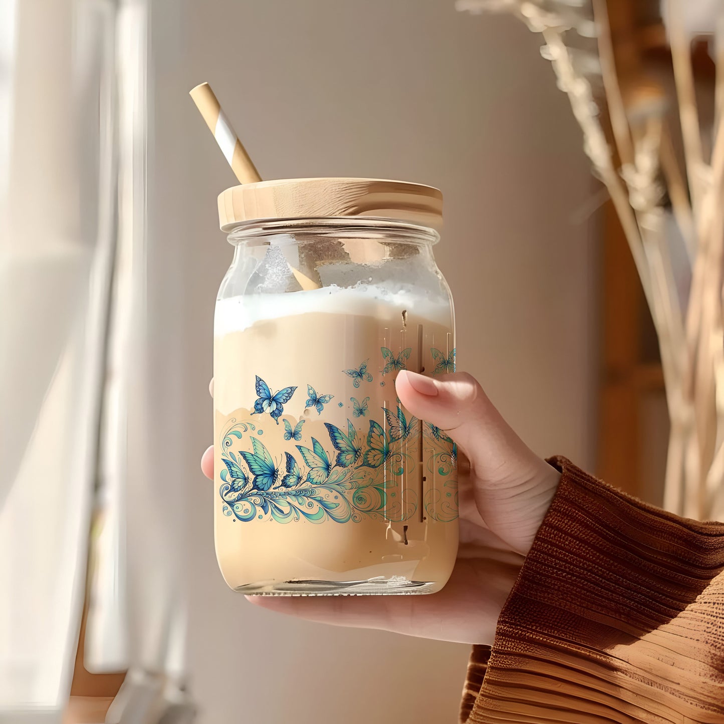 a person holding a jar with a straw in it