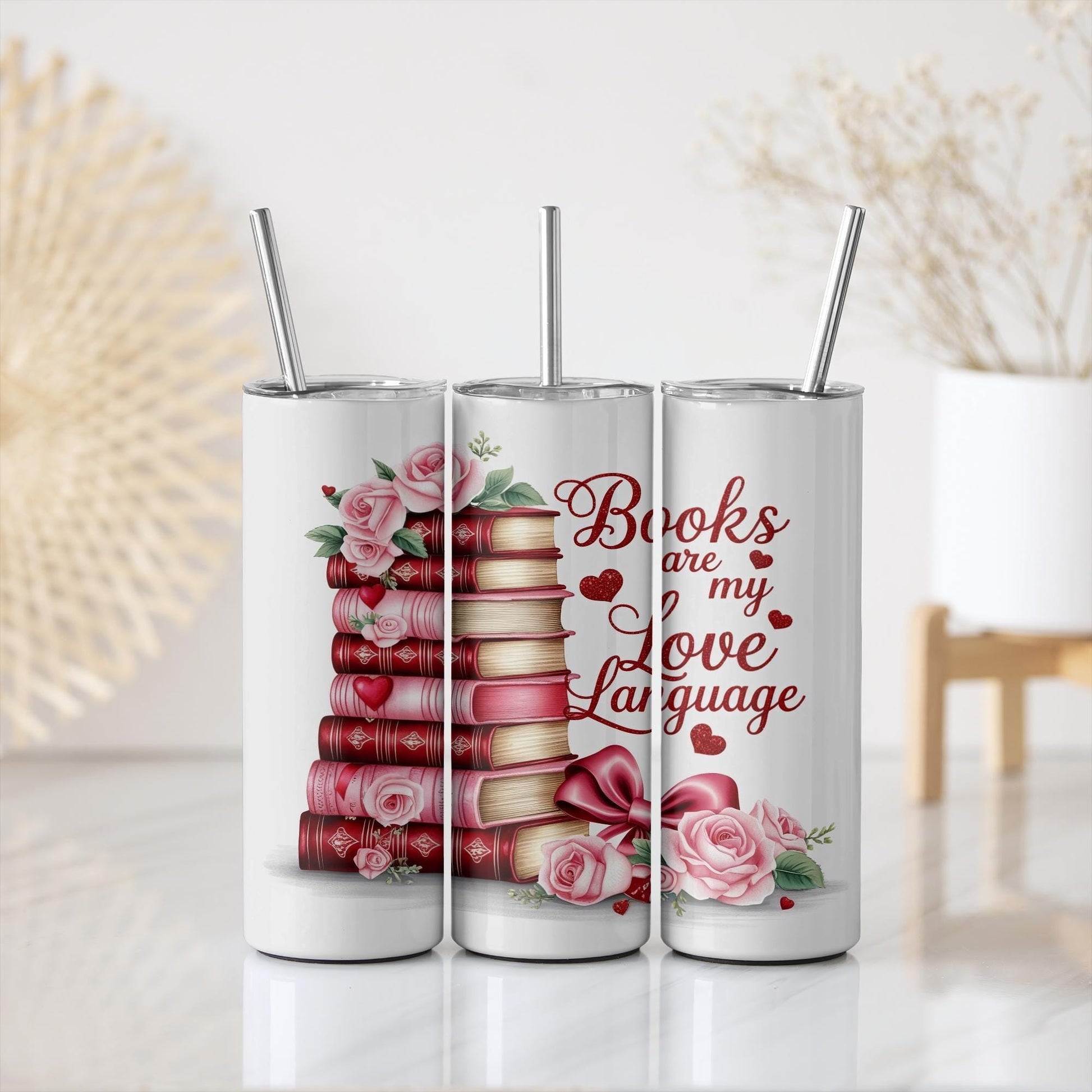 three coffee mugs with a stack of books and roses on them